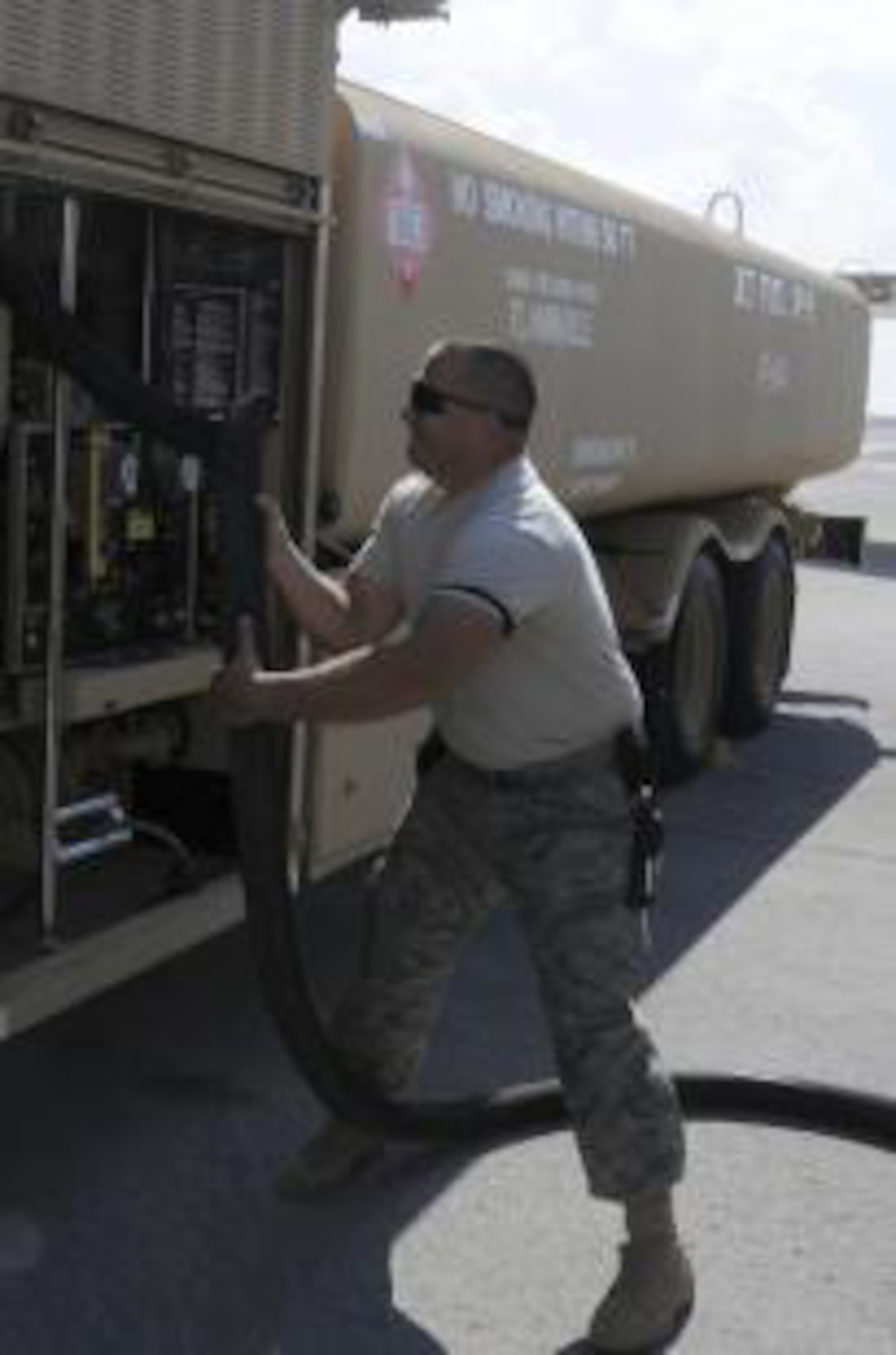 Staff Sgt. Joshua Schubert, 380th Expeditionary Logistics Readiness Squadron distribution supervisor straightens the hose on an R-11 6,000 gallon fuel truck, Jan 21. Sergeant Schubert was assisting during a refueling of an E-3 Sentry. Sergeant Schubert performs checks at random to ensure proper procedures are followed during aircraft refueling. Sergeant Schubert is deployed from Eglin AFB, Fla. and is from Hatboro, Pa. (USAF photo/Staff Sgt. Mike Andriacco)

