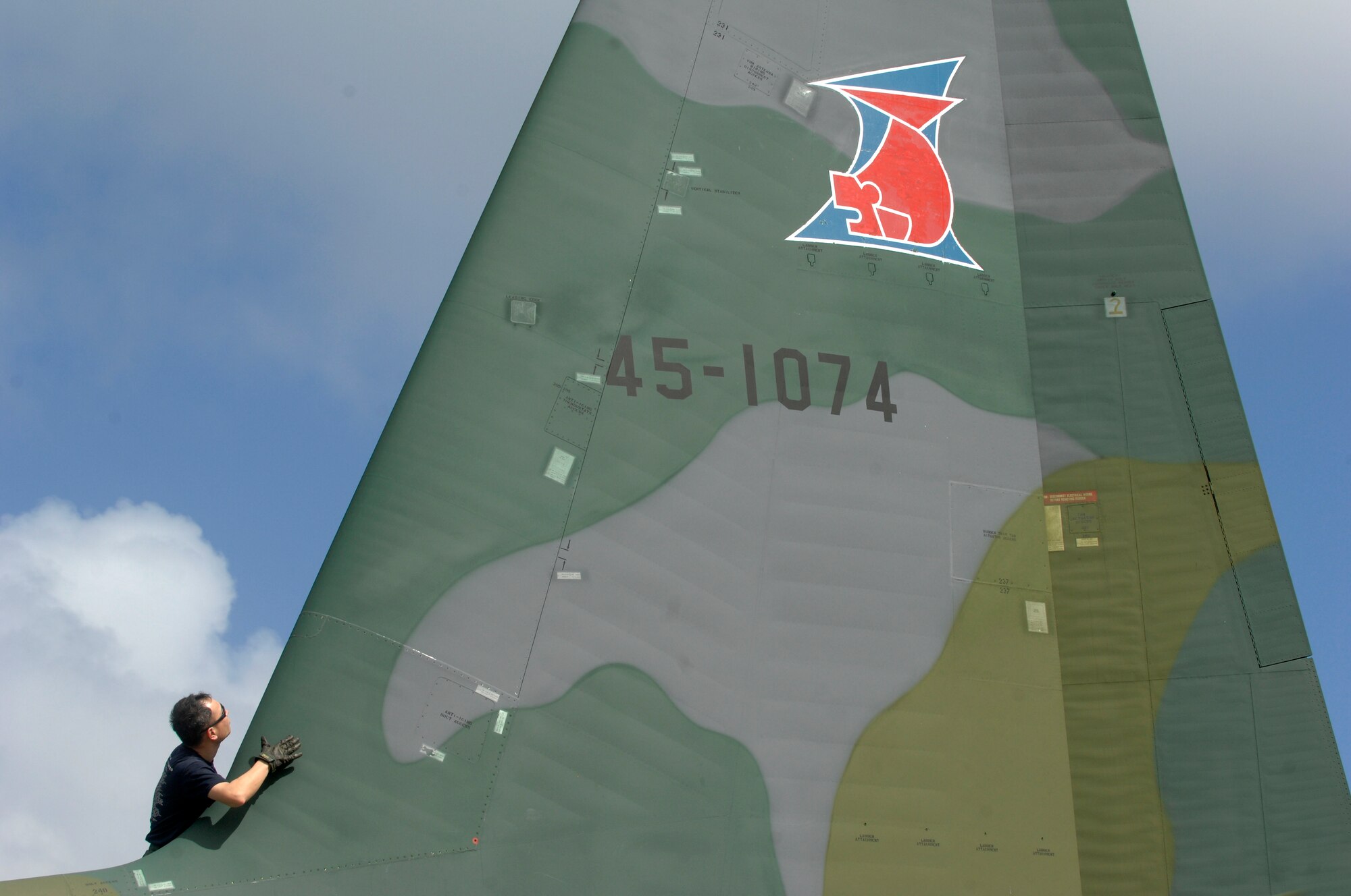 ANDERSEN AIR FORCE BASE, Guam -- A member of the Japan Air Self Defense Force performs post flight maintenance on a JASDF C-130 Hercules after its arrival at Andersen AFB for participation in Exercise Cope North 09-1 Jan. 27.  More than 60 JASDF members arrived in three C-130s to participate in Exercise Cope North 09-1, a regularly scheduled exercise scheduled for Feb. 2-13.  Cope North is designed to enhance U.S. and Japanese air operations in defense of Japan. (U.S. Air Force photo by Master Sgt. Kevin J. Gruenwald)


