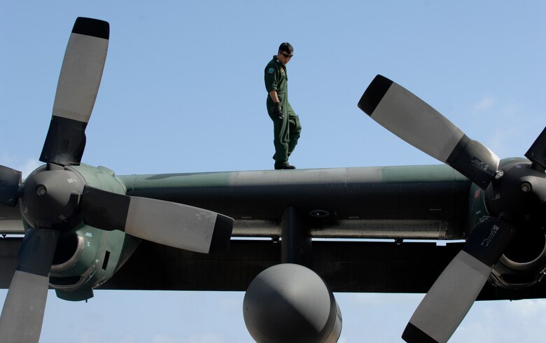 ANDERSEN AIR FORCE BASE, Guam -- A member of the Japan Air Self Defense Force performs post flight maintenance on a JASDF C-130 Hercules after its arrival here for participation in Exercise Cope North 09-1 Jan. 27.  More than 60 JASDF members arrived in three C-130s to participate in Exercise Cope North 09-1, a regularly scheduled exercise scheduled for Feb. 2-13.  Cope North is designed to enhance U.S. and Japanese air operations in defense of Japan. (U.S. Air Force photo by Master Sgt. Kevin J. Gruenwald)


