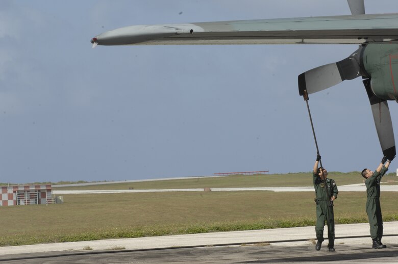 ANDERSEN AIR FORCE BASE, Guam -- Members of the Japan Air Self Defense Force perform post flight maintenance on a JASDF C-130 Hercules after its arrival here for participation in Exercise Cope North 09-1 Jan. 27.  More than 60 JASDF members arrived in three C-130s to participate in Exercise Cope North 09-1, a regularly scheduled exercise scheduled for Feb. 2-13.  JASDF F-2s from the 6th Squadron, Tsuiki Air Base, Japan, and E-2Cs from the 601st Squadron, Misawa Air Base, Japan, will join forward deployed USAF F-16 Fighting Falcons from the 18th Aggressor Squadron, Eielson AFB, Alaska, B-52 Stratofortress currently deployed to Andersen from the 23rd Expeditionary Bomb Squadron, and Navy EA-6B from VAQ-136 Carrier Air Wing Five, Atsugi, Japan, will participate in this year's exercise with a focus on interoperability.  (U.S. Air Force photo by Master Sgt. Kevin J. Gruenwald) 