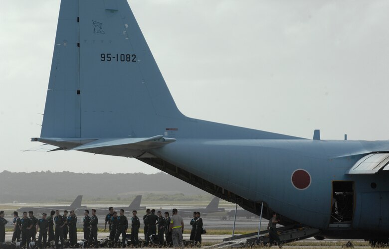 ANDERSEN AIR FORCE BASE, Guam -- Members of the Japan Air Self Defense Force wait outside of their C-130 Hercules after arriving here for participation in Exercise Cope North 09-1 Jan. 27.  More than 60 JASDF members arrived in three C-130s to participate in Exercise Cope North 09-1, a regularly scheduled exercise scheduled for Feb. 2-13.  Cope North is designed to enhance U.S. and Japanese air operations in defense of Japan. JASDF F-2s  from the 6th Squadron, Tsuiki Air Base, Japan, and E-2Cs from the 601st Squadron, Misawa Air Base, Japan, will join forward deployed USAF F-16 Fighting Falcons from the 18th Aggressor Squadron, Eielson AFB, Alaska, B-52 Stratofortress' currently deployed to Andersen from the 23rd Expeditionary Bomb Squadron, and Navy EA-6B from VAQ-136 Carrier Air Wing Five, Atsugi, Japan, will participate in this year's exercise with a focus on interoperability.  
(U.S. Air Force photo by Master Sgt. Kevin J. Gruenwald)


