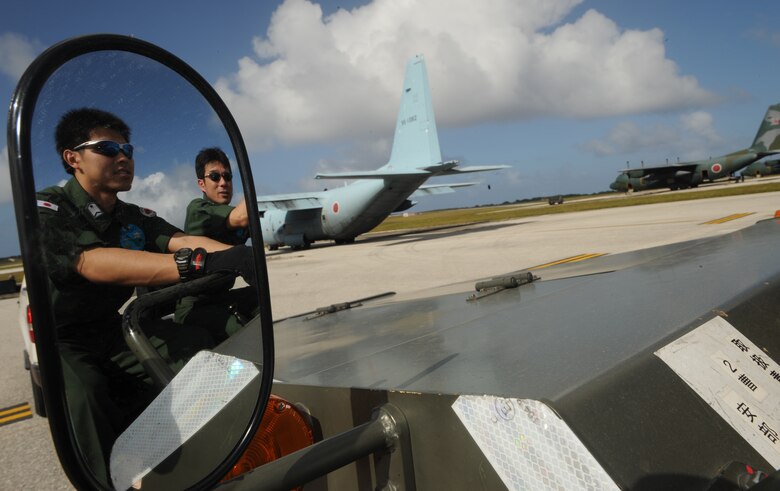 ANDERSEN AIR FORCE BASE, Guam -- Members of the Japan Air Self Defense Force prepare to offload equipment after arriving here in a JASDF C-130 Hercules Jan 27.  More than 60 JASDF members arrived in three C-130s to participate in Exercise Cope North 09-1, a regularly scheduled exercise scheduled for Feb. 2-13.  Cope North is designed to enhance U.S. and Japanese air operations in defense of Japan.  (U.S. Air Force photo by Master Sgt. Kevin J. Gruenwald) 

