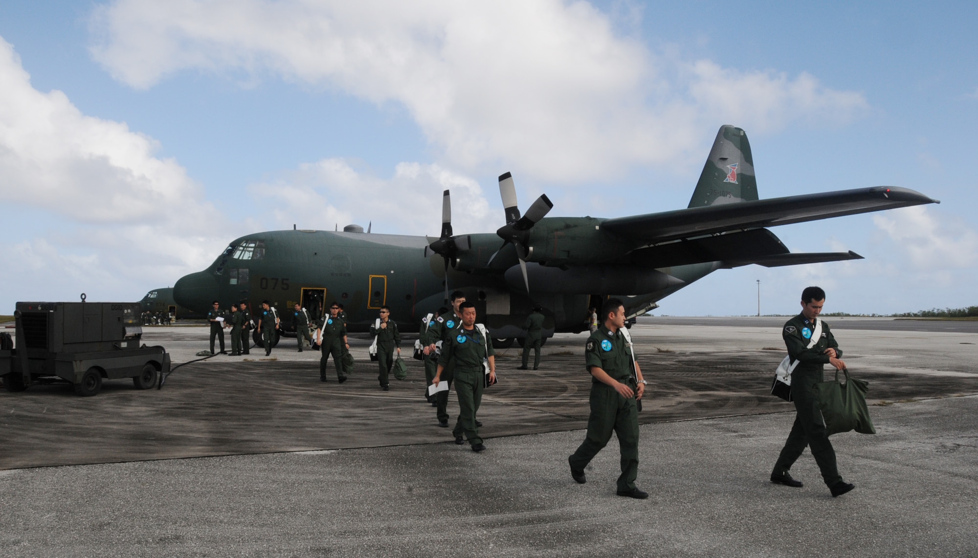 ANDERSEN AIR FORCE BASE, Guam -- Members of the Japan Air Self Defense Force offload after arriving here in a JASDF C-130 Hercules Jan 27.  More than 60 JASDF members arrived in three C-130s to participate in Exercise Cope North 09-1, a regularly scheduled exercise scheduled for Feb.2-13.  Cope North is designed to enhance U.S. and Japanese air operations in defense of Japan.  (U.S. Air Force photo by Senior Airman Ryan Whitney)

