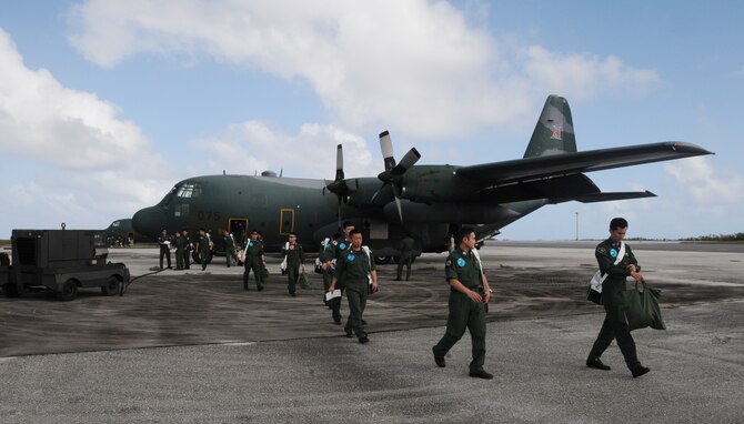 ANDERSEN AIR FORCE BASE, Guam -- Members of the Japan Air Self Defense Force offload after arriving here in a JASDF C-130 Hercules Jan 27.  More than 60 JASDF members arrived in three C-130s to participate in Exercise Cope North 09-1, a regularly scheduled exercise scheduled for Feb.2-13.  Cope North is designed to enhance U.S. and Japanese air operations in defense of Japan.  (U.S. Air Force photo by Senior Airman Ryan Whitney)

