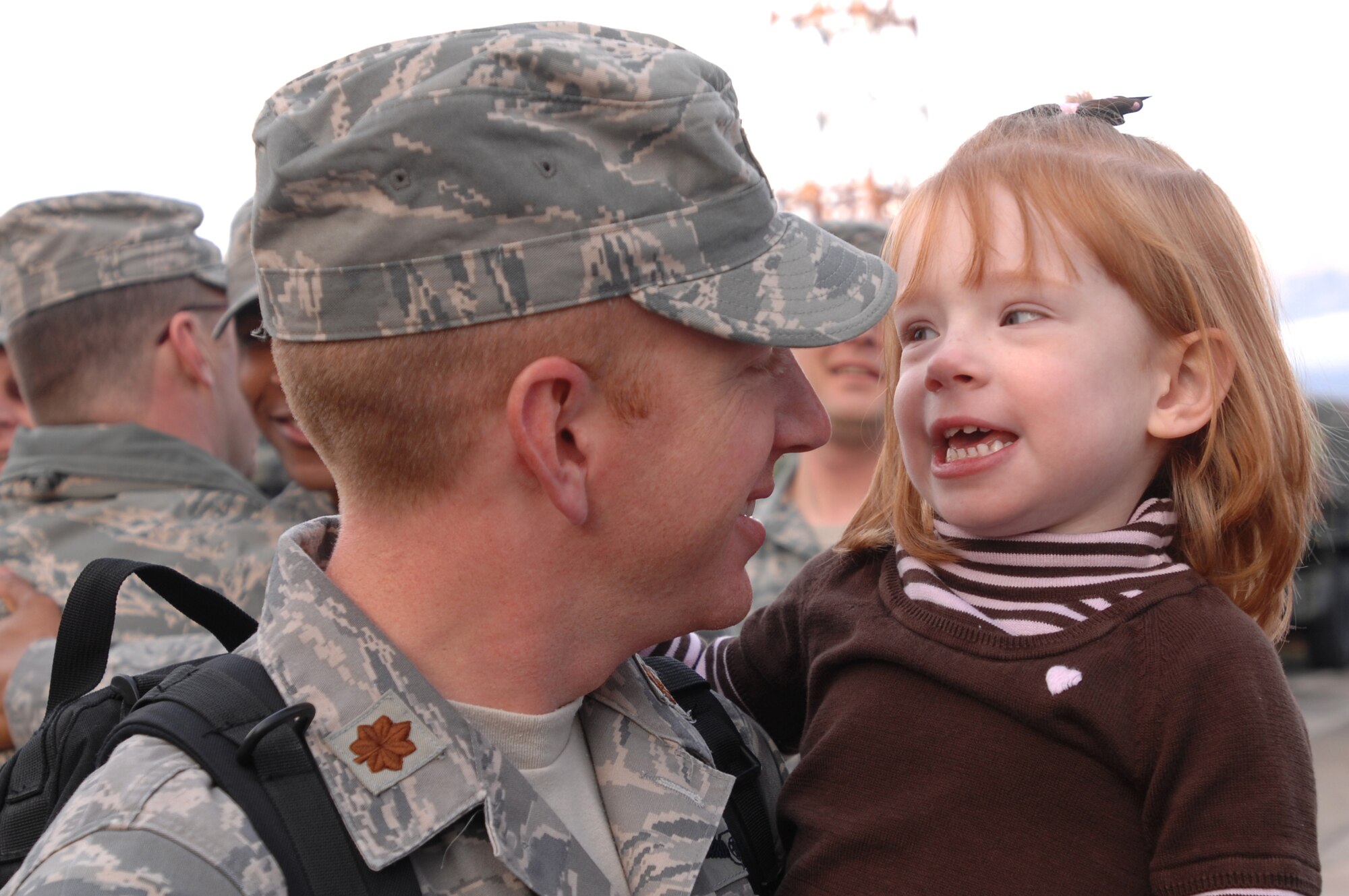 Samantha, 4, gets reacquainted with her dad, Maj. Robert Peacock, 603rd Air Control Squadron combat readiness flight commander Jan. 24 following the return from his Air Expeditionary Force 5/6 deployment to Southwest Asia in support of Operation Iraqi and Enduring Freedom and Joint Task Force-Horn of Africa.  Major Peacock was the deployed commander of the 71st EACS. (U.S. Air Force photo/ Staff Sgt. Patrick Dixon)