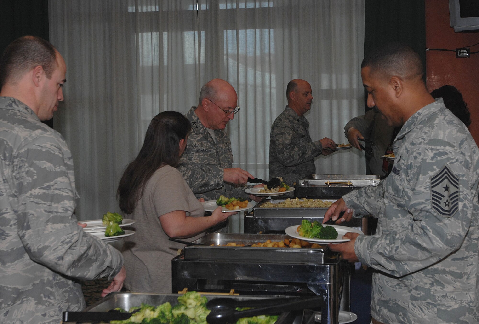 Chaplain (Maj. Gen.) Cecil Richardson, Air Force Chief of Chaplains, processes through the buffet line along with 31st Fighter Wing senior leadership after the start of the base National Prayer Luncheon Jan. 22 at the La Bella Vista Club. Chaplain Richardson was the guest speaker at the luncheon. (U.S. Air Force photo/Tech. Sgt. Patrick Hyde)