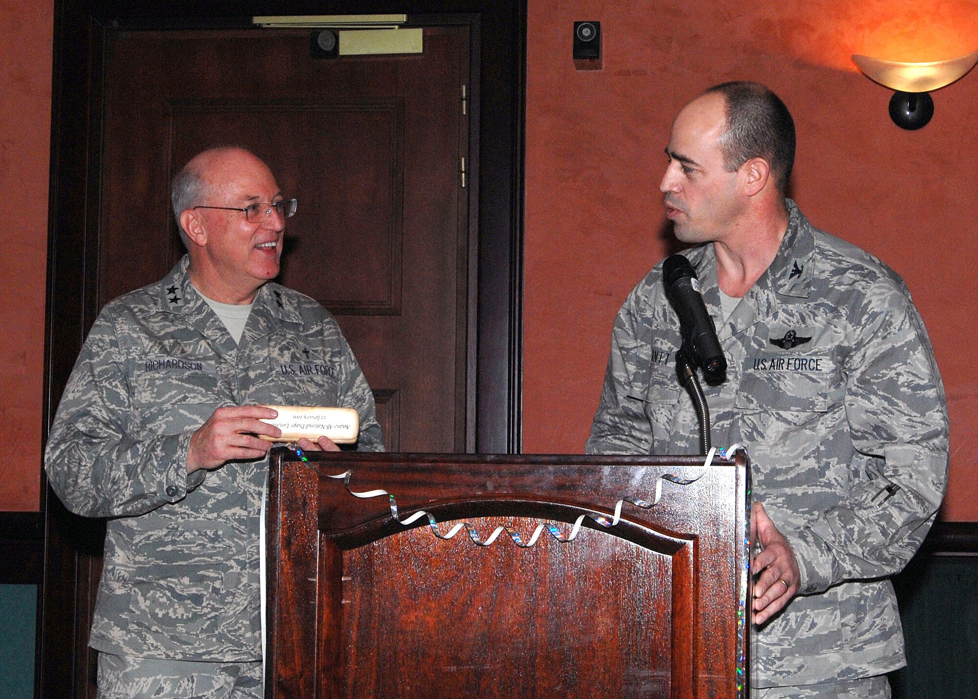 Col. Michael Gantt, 31st Fighter Wing vice commander, presents Chaplain (Maj. Gen.) Cecil Richardson, Air Force Chief of Chaplains, with a special memento on behalf of Aviano Air Base for being the guest speaker of the base's National Prayer Luncheon Jan. 22 at the La Bella Vista Club. (U.S. Air Force photo/Tech. Sgt. Patrick Hyde)