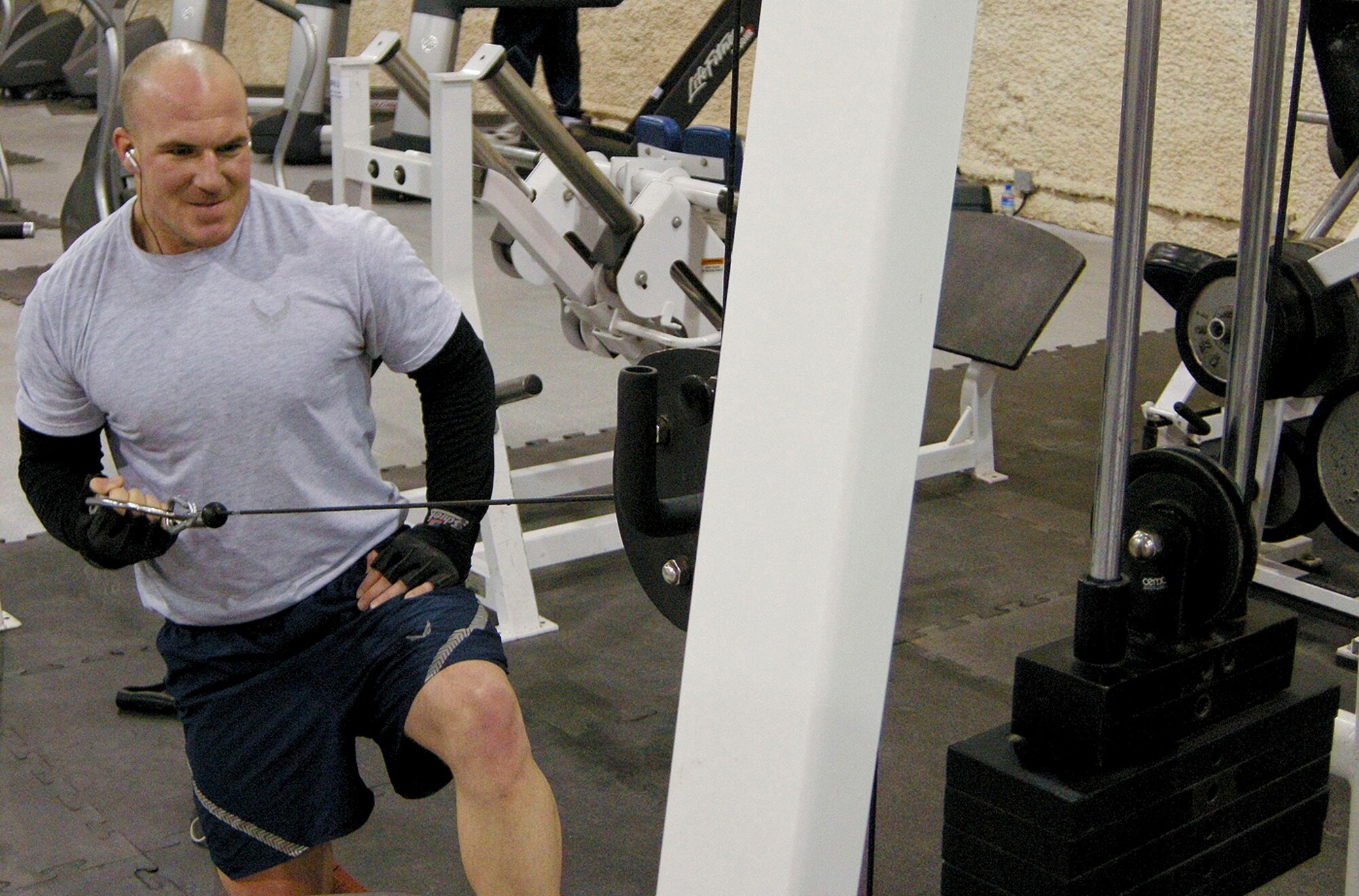 Airman 1st Class Jon Little, 455th Expeditionary Security Forces Squadron, performs single arm back row exercises to strengthen his back and lateral muscles at the new Camp Cunningham fitness center at Bagram Air Field Jan. 17.  Airman Little is deployed here from the 9th Security Forces Squadron at Beale Air Force Base, Calif. 