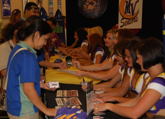 ANDERSEN AIR FORCE BASE, Guam - Minnesota Vikings Cheerleaders sign autographs for Airmen and their families at the base exchange here Jan. 26. The squad spent the day touring the base and capped off their visit with a performance at the base theater. (U.S. Air Force photo by Senior Airman Shane Dunaway)