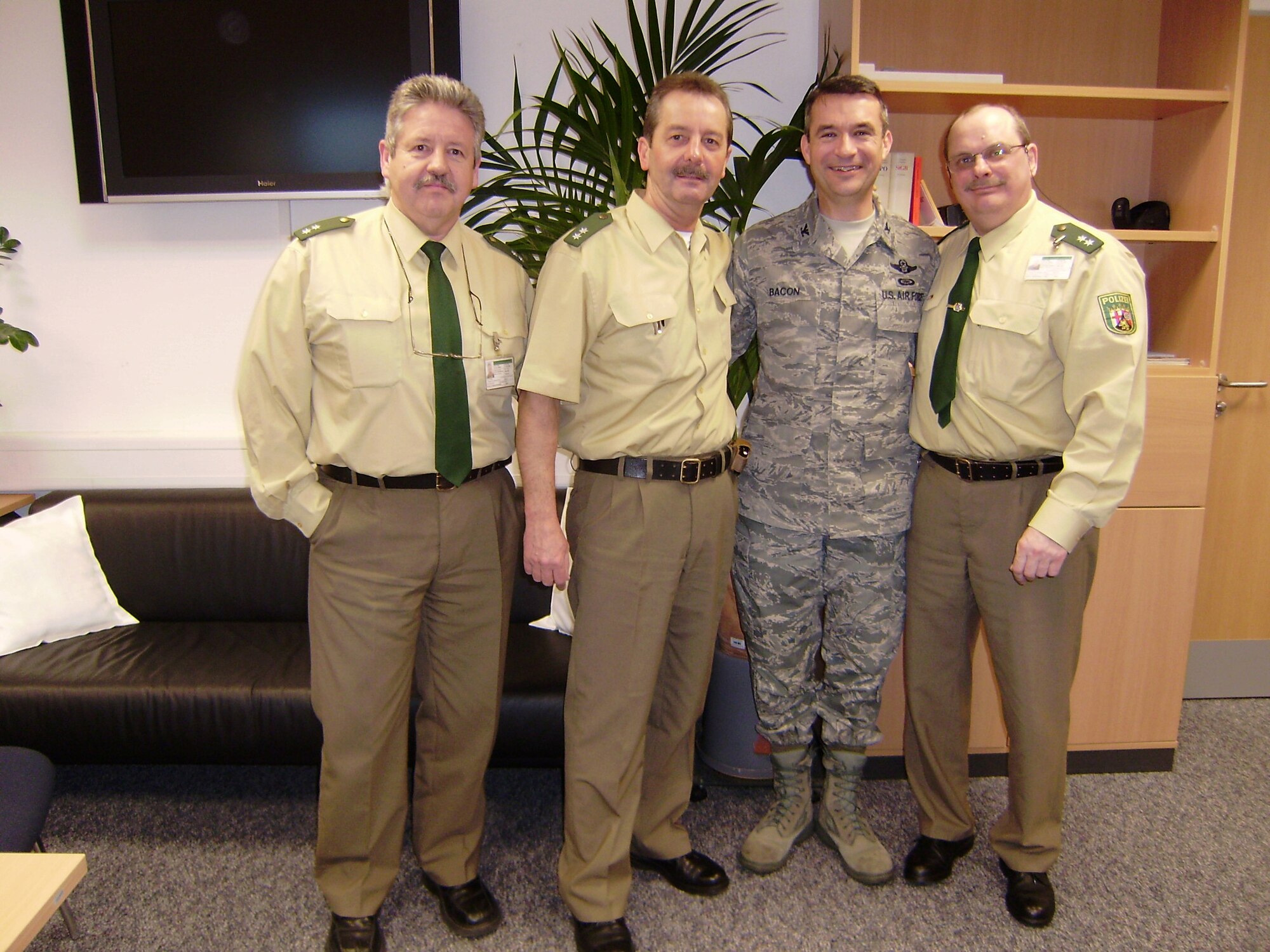 Col. Donald Bacon, 435th Air Base Wing commander, meets with Ramstein Polizei Liaison Officers (from left) Lt. Alfred Klein, Lt. Peter Stein and Lt. Bernd Riffel. The liaison office is in its fifth year on base and is the only one of its kind in Germany. "I'm very grateful for the close rapport and teamwork we have with our German Polizei. This team works hard to ensure the security of Team Ramstein," Colonel Bacon said. (Courtesy photo)     