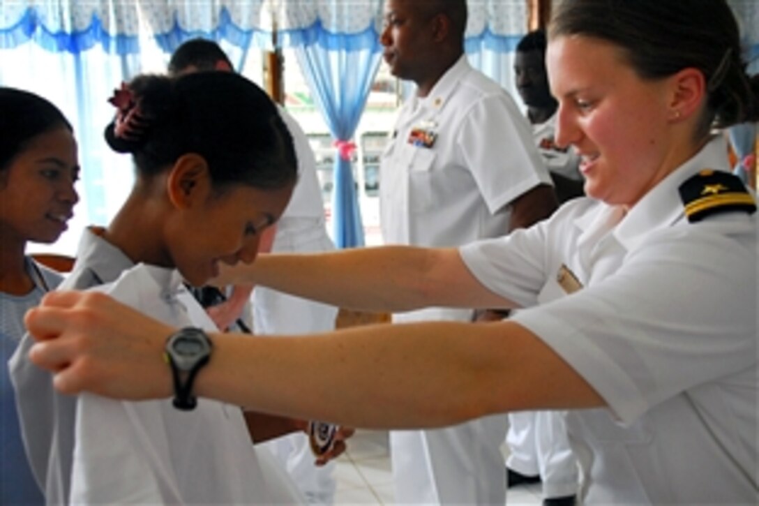 U.S. Navy Lt. j.g. Kristina Rohlin checks the size of a shirt before giving it to a girl at the Missionary Dominican Sisters of the Rosary Orphanage in Dili, Timor-Leste, Jan. 26, 2009. 