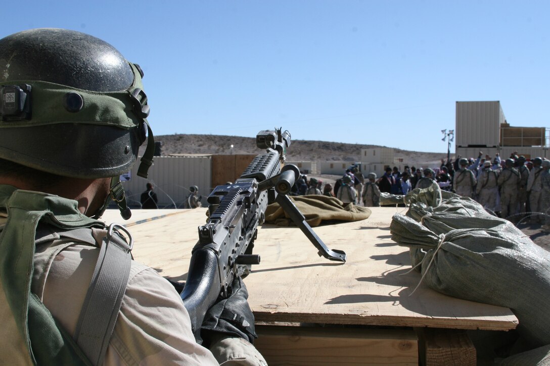 An Iraqi Army role player provides security from a machine gun nest during a riot in Al Wahde, a training town at the Army’s National Training Center Fort Irwin, Calif., Jan. 28.  The Marines and sailors of 3rd Light Armored Reconnaissance Battalion spent two weeks at Fort Irwin preparing for their upcoming deployment to Iraq this spring.