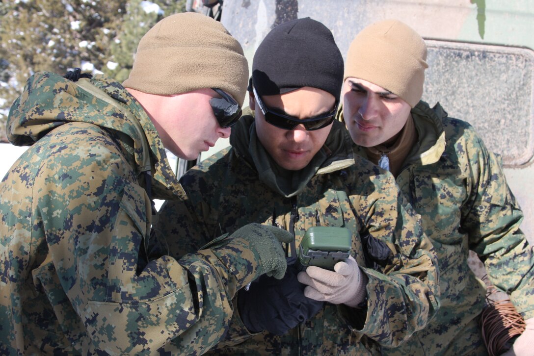 Cpl. Colby F. Staples, Cpl. Jefferson A. Saures and Lance Cpl. Antonio E. Reyes, field radio operators with 3rd battalion, 4th Marine Regiment, use a “dagger” or GPS location devise, to determine their angle of azymuth before setting up a communication station at the Brownie Creek parking lot during an abbreviated version of the Mountain Command and Control Communication Course offered at the Marine Corps Mountain Warfare Training Center Bridgeport, Calif., Jan. 29.