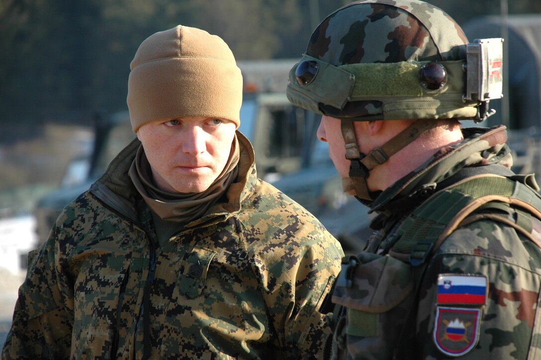 Staff Sgt. Emir Hadzic (left), Marine Forces Europe non-lethal weapons instructor and training chief, listens to a question from a Slovenian soldier after a non-lethal weapons education session here Jan. 30. Hadzic and two other NLW instructors from Marine Forces Europe traveled here to conduct the training for the Slovenians and soldiers from the California National Guard as part of the soldier?s predeployment training in preparation for an upcoming rotation with the NATO-led Kosovo Force.