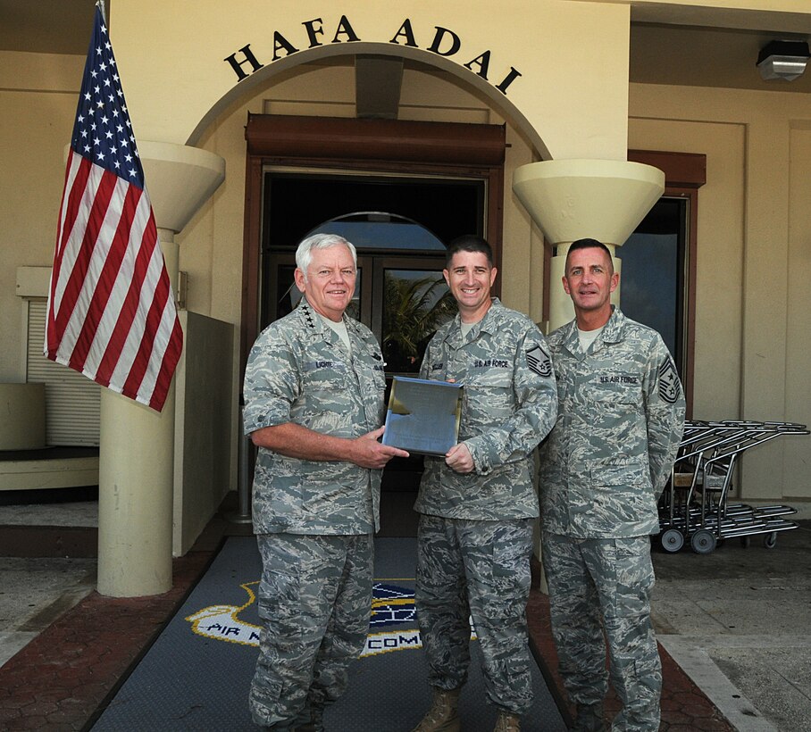 ANDERSEN AIR FORCE BASE, Guam -- Air Mobility Command's commander Gen. Arthur Lichte and Command Chief Master Sgt. Joseph Barron Jr., presents a Distinguished Ground Safety Award (Associate/Tenant) 2008 to Master Sgt. Troy Mueller, 734th Air Mobility Squadron, safety superintendant, who accepted the award on behalf of the 734th AMS here Jan. 28. The 734th AMS received this award due to their performance throughout 2008.  (U.S. Air Force photo by Airman 1st Class Carissa Wolff)