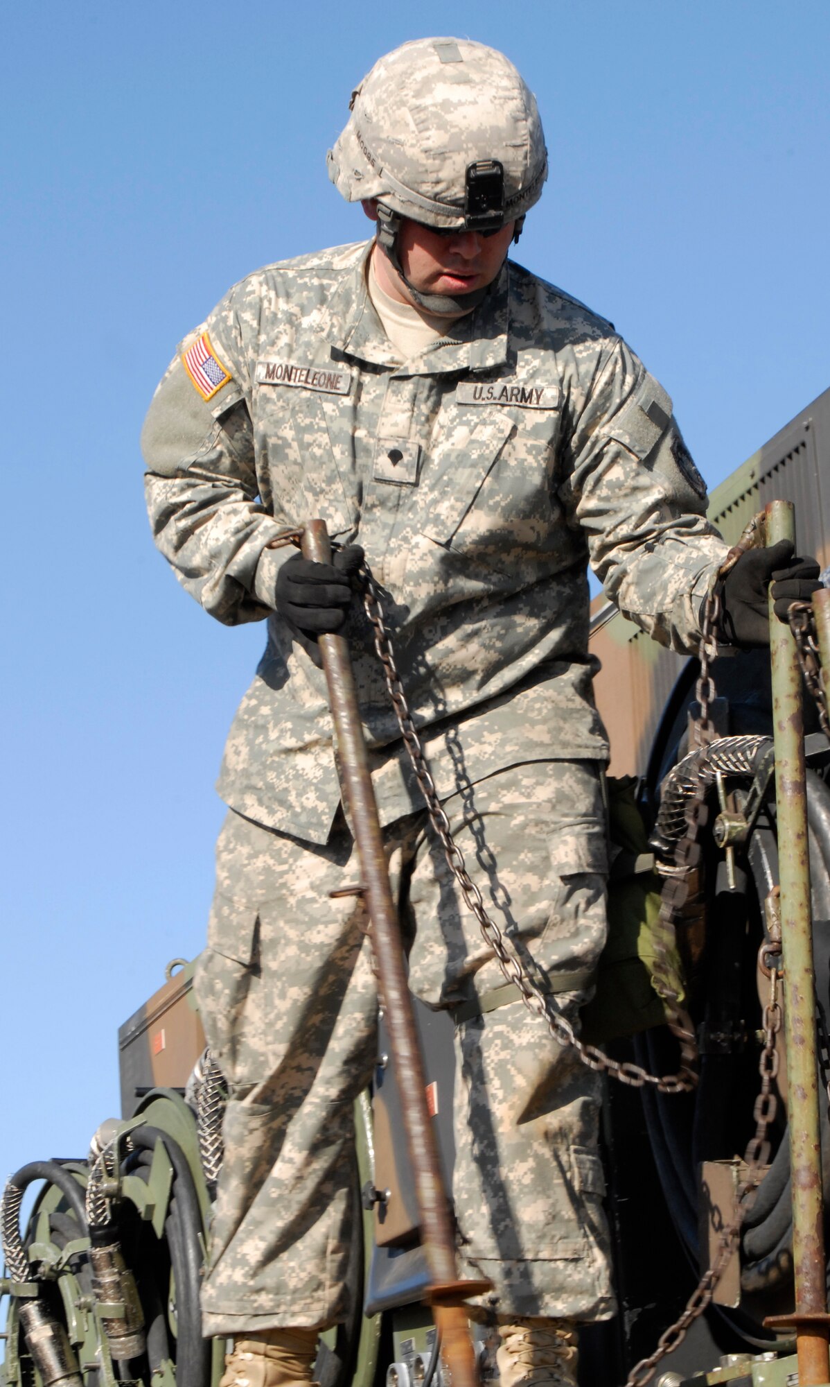 U.S. Army Spc. Jeff Monteleone, Alpha  4th Battalion - 5th Air Defense Artillery Regiment Electrical power plant crew member, installs safety rails onto a temporary electrical power plant during an Army Table 8 evaluation at Kunsan Air Base, Republic of Korea Jan. 28. The Army air defense Soldiers and their Patriot missile batteries are key members of the Wolf Pack, vital to the mission of defending the base. (U.S. Air Force photo by: Senior Airman Dana Hill)