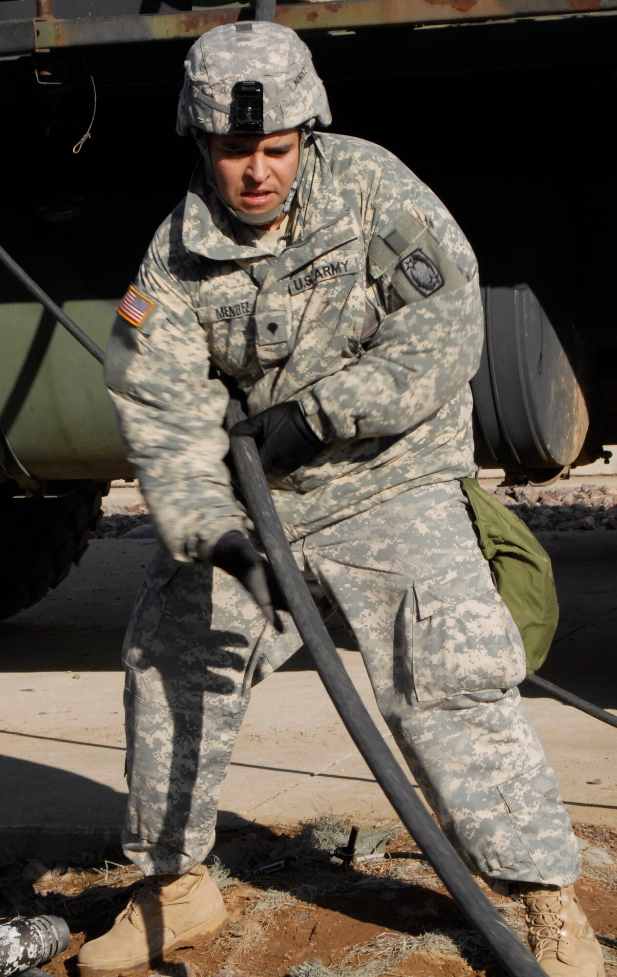 U.S. Army Spc. Arnold Mendez, Alpha  4th Battalion - 5th Air Defense Artillery Regiment patriot switch maintainer operator, reels cables into the temporary electrical power plant during an Army table 8 evaluation at Kunsan Air Base, Republic of Korea Jan. 28. The Table 8 evaluation evaluates the Army's combat effectiveness and their ability to get ready for the fight and sustain the fight. (U.S. Air Force photo by: Senior Airman Dana Hill)