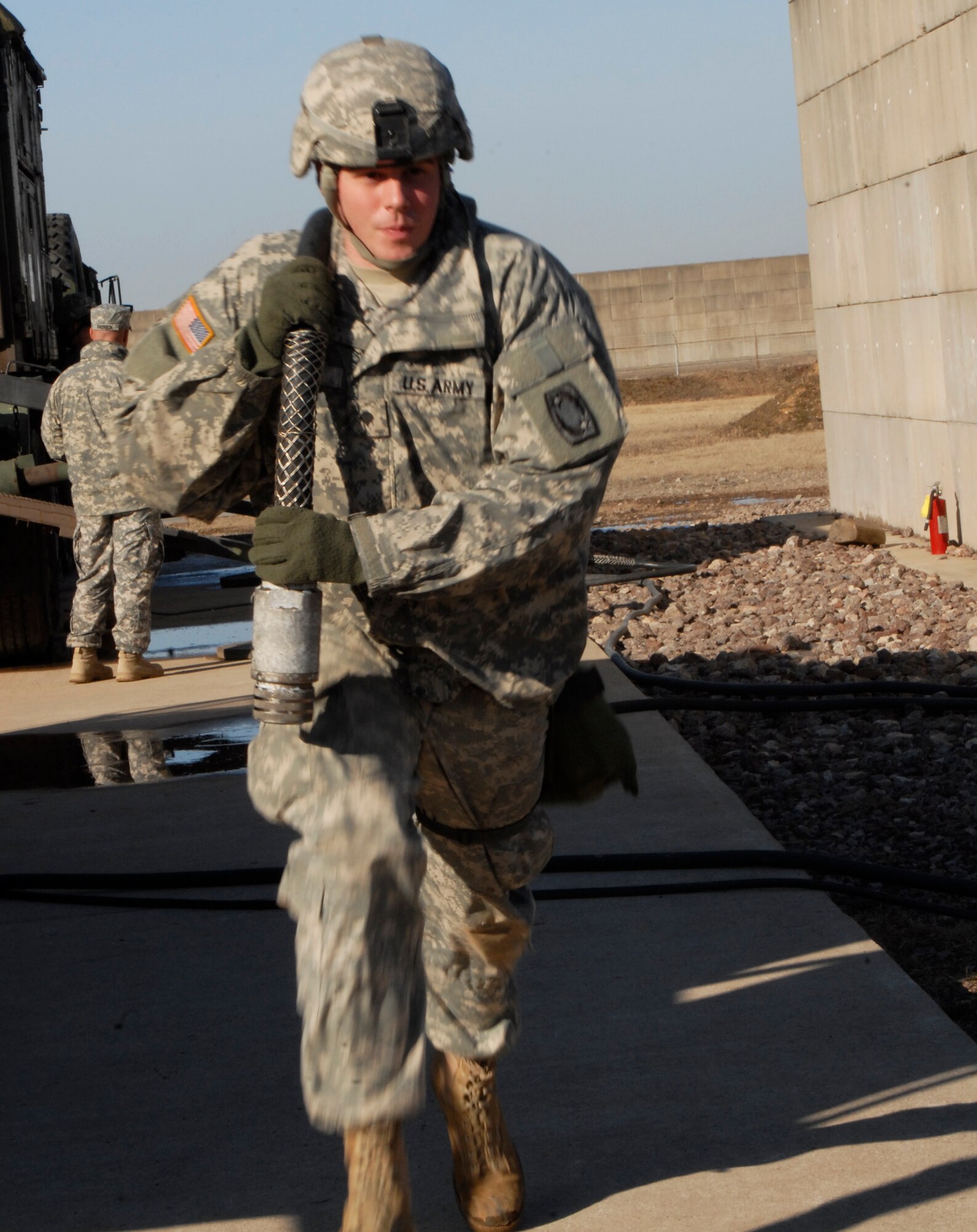 U.S. Army Spc. Gayon Gibson, Alpha 4th Battalion - 5th Air Defense Artillery Regiment radar crew member, disconnects and runs cables from the radar to the temporary electrical power plant during an Army Table 8 evaluation at Kunsan Air Base, Republic of Korea Jan. 28. The Table 8 evaluation evaluates the Army's combat effectiveness and their ability to get ready for the fight and sustain the fight. (U.S. Air Force photo by: Senior Airman Dana Hill)