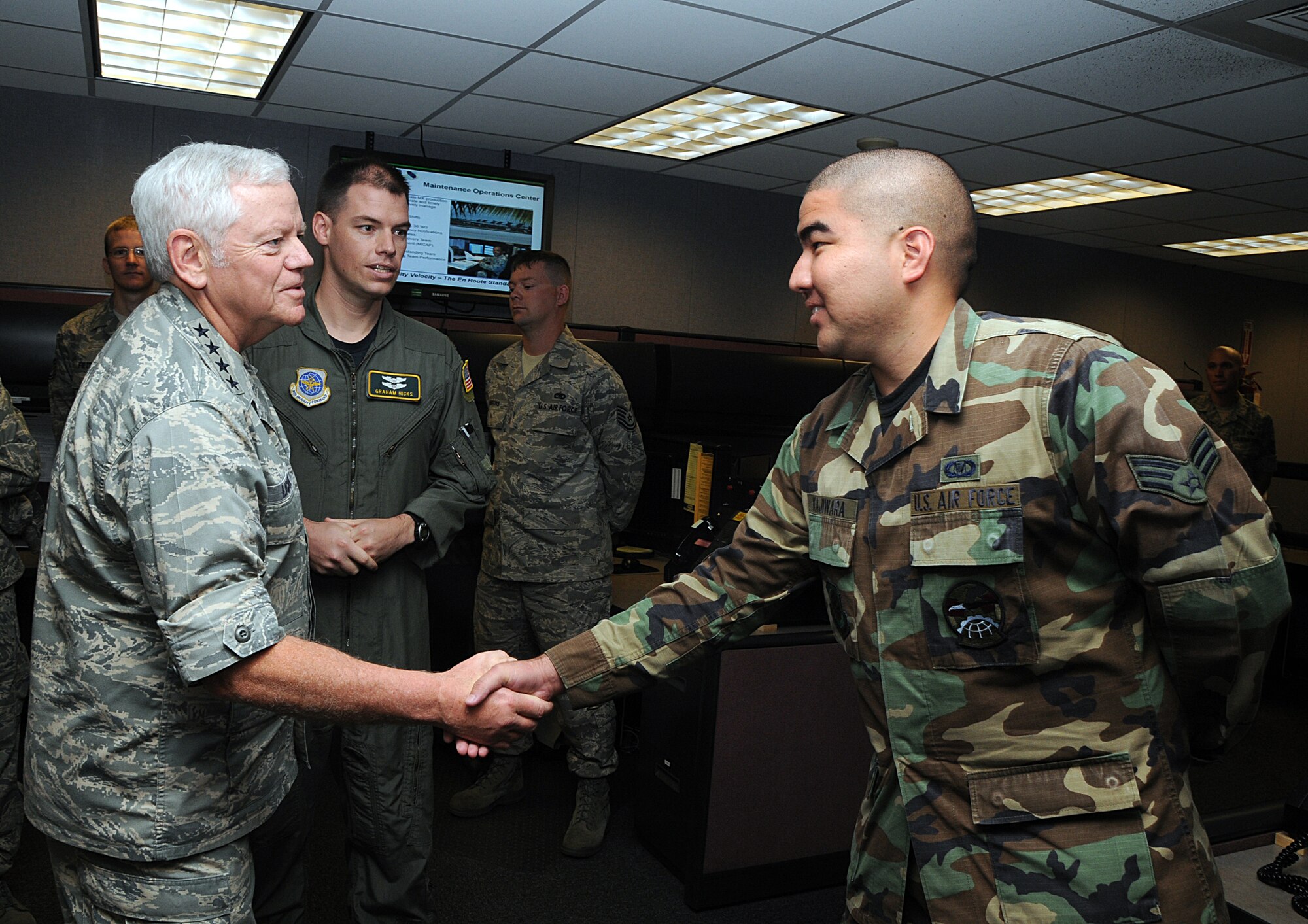 ANDERSEN AIR FORCE BASE, Guam -- Gen. Arthur Lichte, Air Mobility Command commander, shakes hands with Senior Airman Jaime Kajiwara, 734th Air Mobility Squadron, air mobility control center controller, during his visit here Jan. 28. General Lichte visited Team Andersen on his way to New Zealand where he will embed on Operation DEEP FREEZE missions. (U.S. Air Force photo by Airman 1st Class Carissa Wolff)