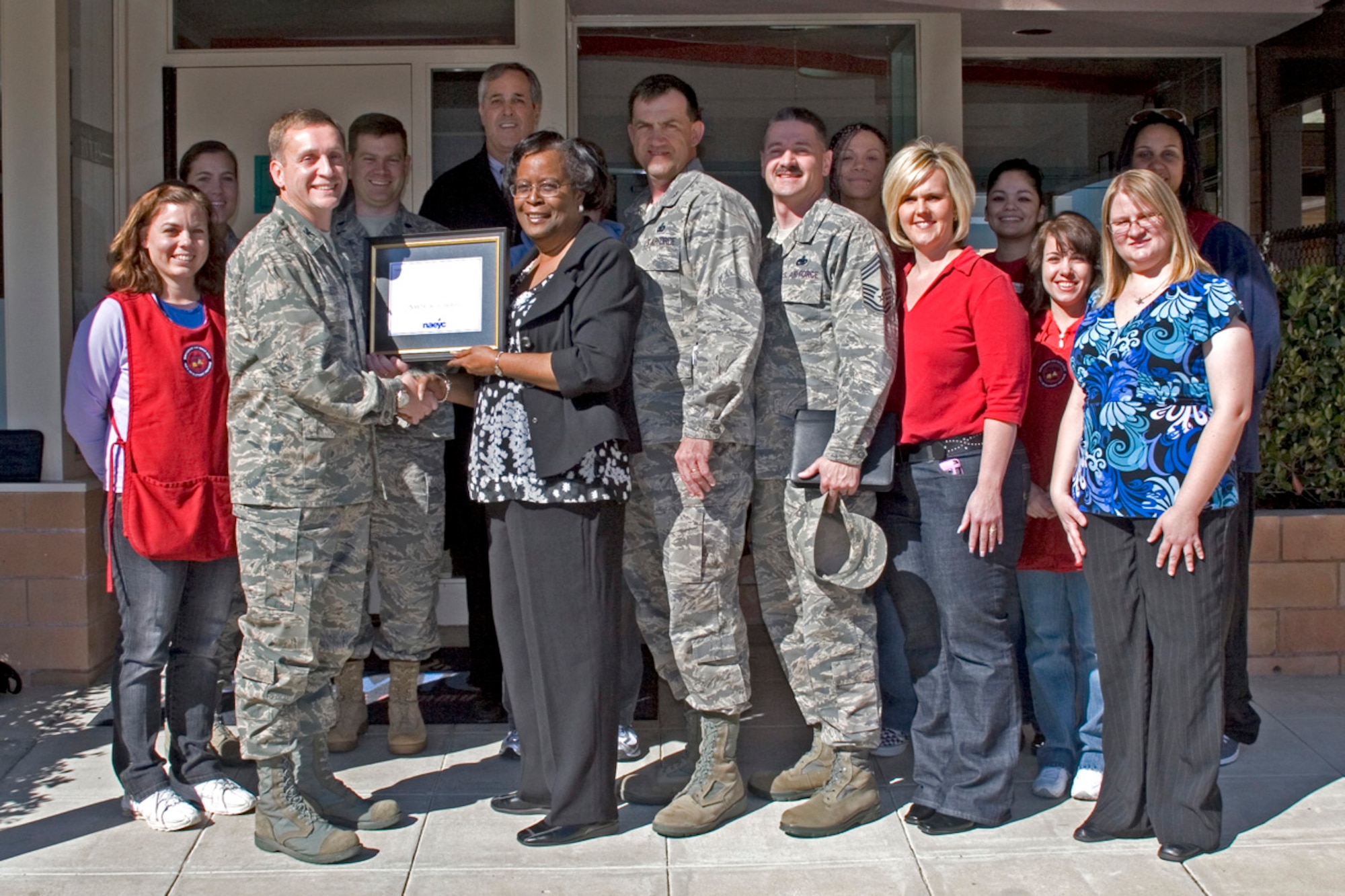 VANDENBERG AIR FORCE BASE, Calif. -- Verna Brown, director of the Child Development Center, recieves a certificate for the CDC's accreditation from the National Association for the Education of Young Children from the 30th Space Wing commander Col. David Buck. (Air Force courtesy photo)