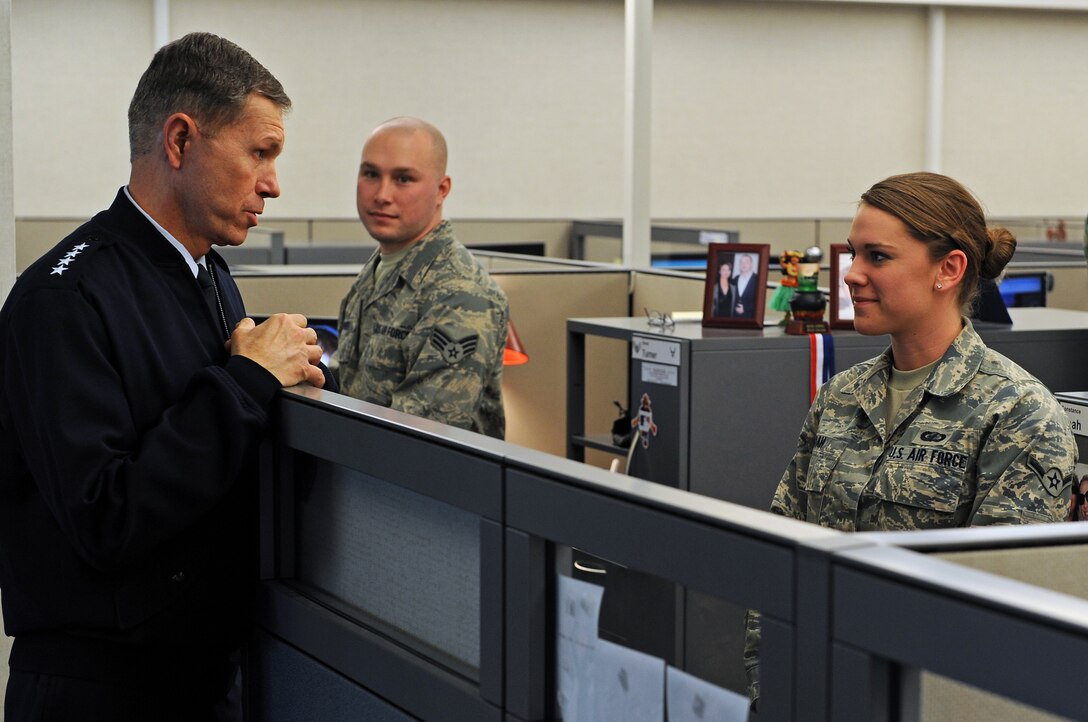 (Left) Gen. William M. Fraser III, U.S. Air Force Vice Chief of Staff, talks with Airman Constance Noah, Air Force Financial Services Center military pay technician, during a base tour, Jan 23. The AFFSC centrally processes all military pay, travel pay and transactions for the Air Force. (U.S. Air Force photo/Senior Airman Marc I. Lane)