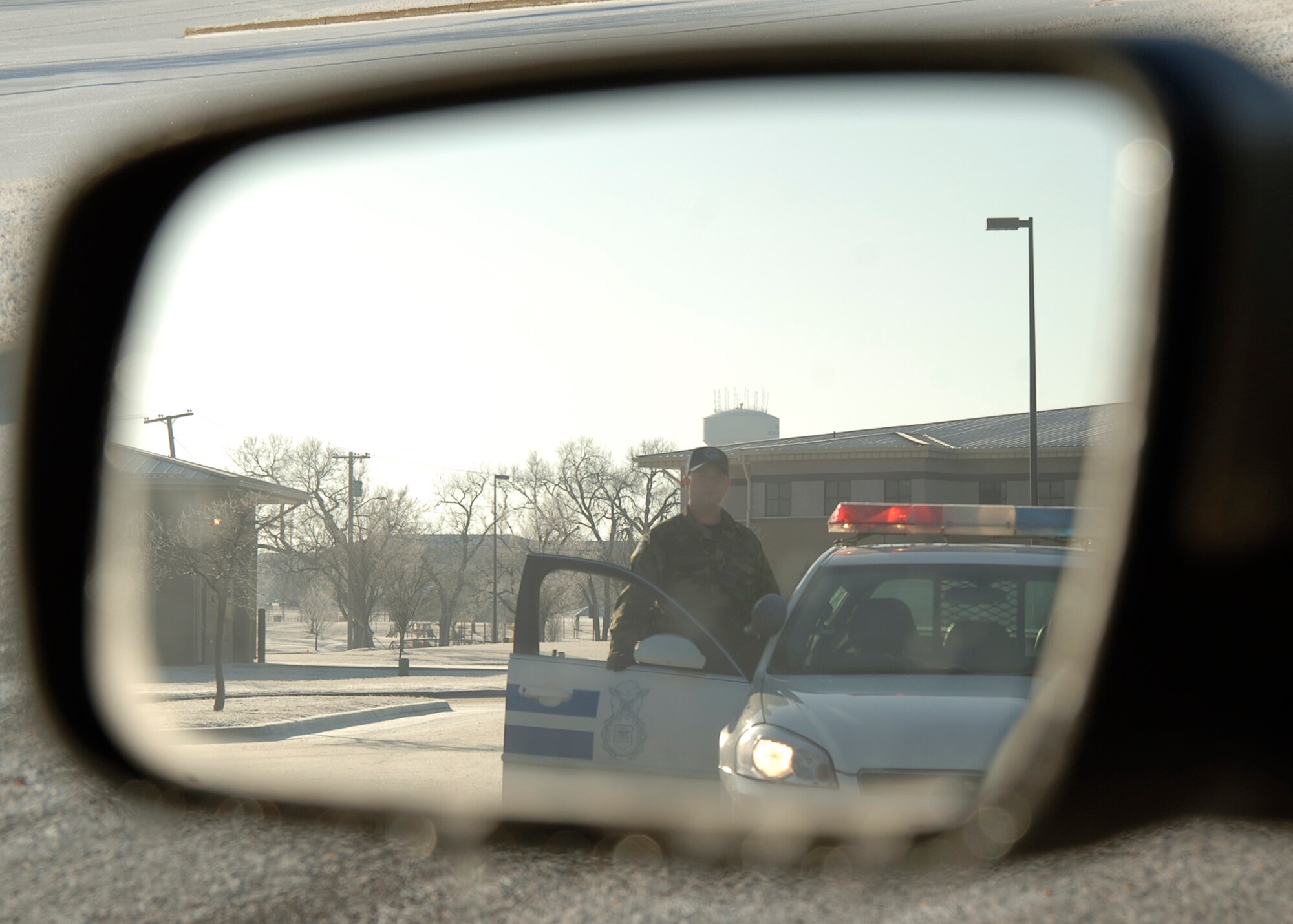 MCCONNELL AIR FORCE BASE, Kan. -- Gregory Cohen, 22nd Security Forces Squadron, steps out of his response vehicle to approach a moving traffic law violator, Jan. 28. (Photo by Staff Sgt. Ronald Lafosse)