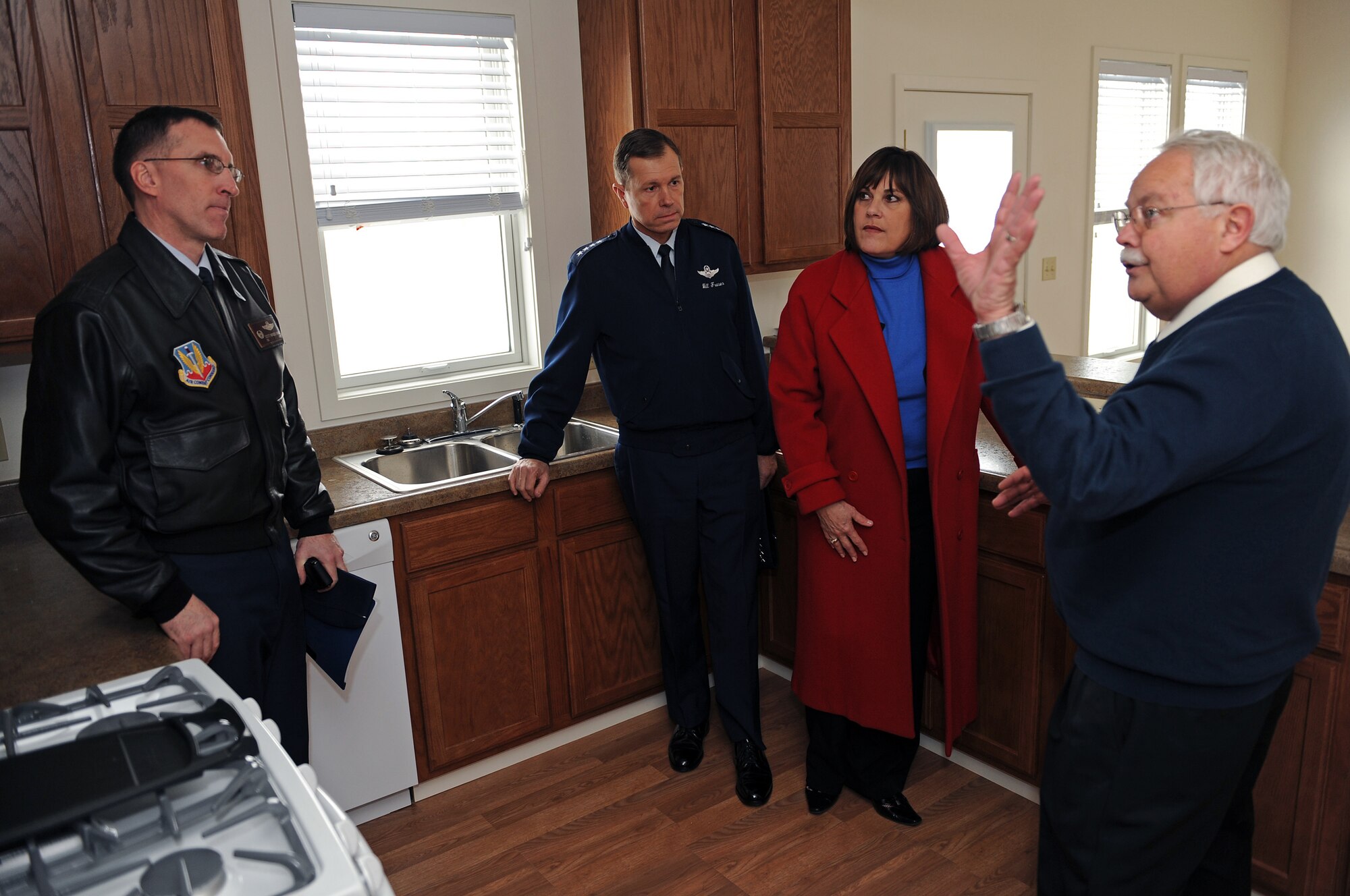 (From right) Larry Herges, 28th Civil Engineer Squadron architect, describes the kitchen features in the new base housing units to Mrs. Bev Fraser, Gen. William M. Fraser III, U.S. Air Force Vice Chief of Staff, and Col. Scott Vander Hamm, 28th Bomb Wing commander, during a tour of base housing, Jan 23.  The 28 CES plans on opening 56 more four bedroom units for junior enlisted personnel. (U.S. Air Force photo/Senior Airman Marc I. Lane)
