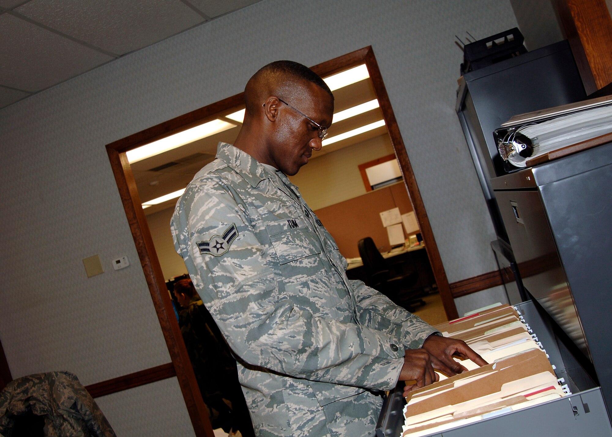 MCCONNELL AIR FORCE BASE, Kan. -- Airman 1st Class Moses Tum, 22nd Comptroller Squadron financial management, files processed travel vouchers at the finance office, Jan. 27. After travel vouchers are cleared and processed through finance, they must be maintained for tracking purposes. (Photo by Senior Airman Anthony Mejia) 