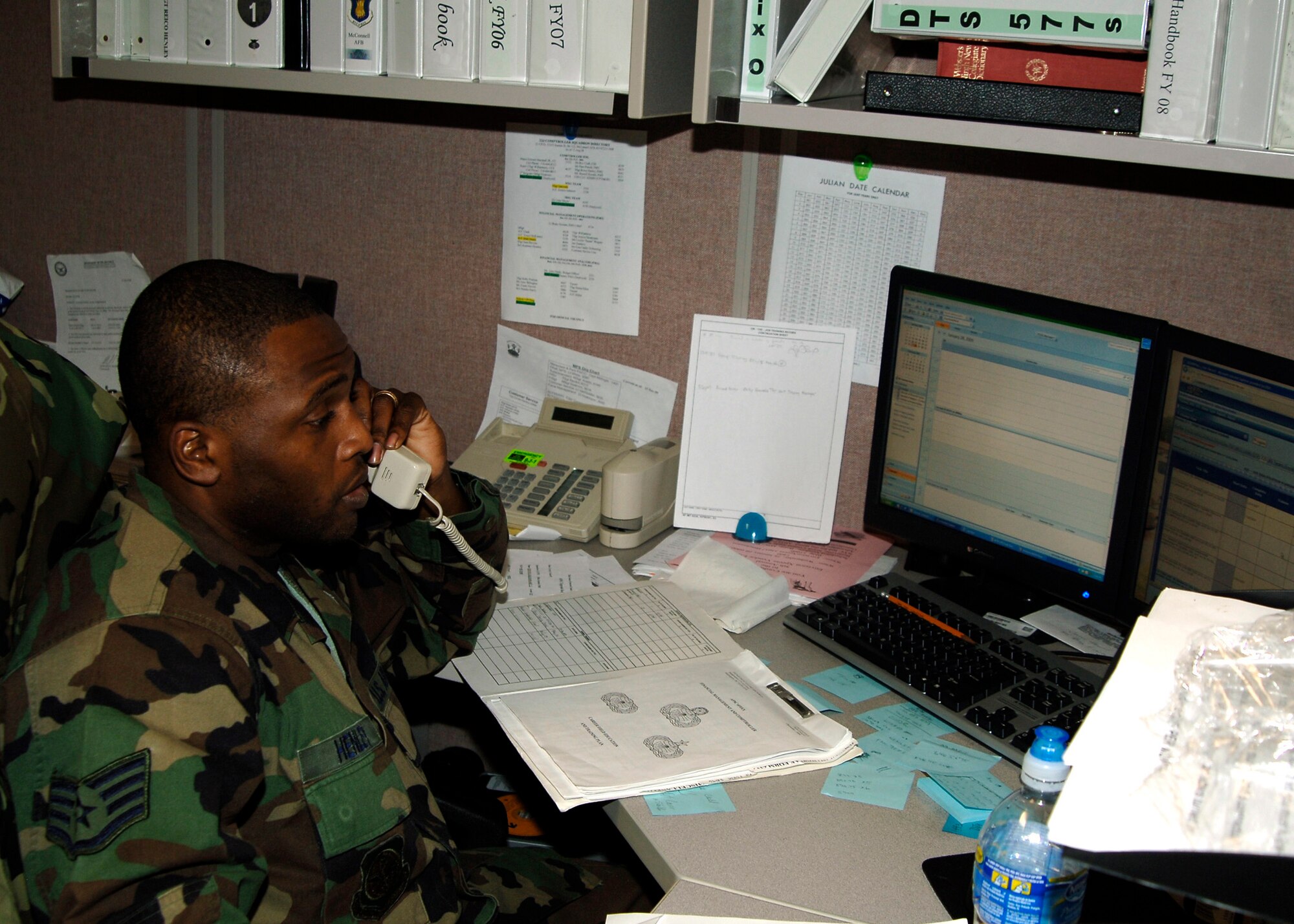 MCCONNELL AIR FORCE BASE, Kan. -- Staff Sgt. Reico Henley, 22nd Comptroller Squadron financial management, walks a customer through steps of using the Defense Travel System at the finance office, Jan. 27. The DTS is an on-line program that helps Department of Defense members pay for flights, hotels and rental cars when traveling on orders. (Photo by Senior Airman Anthony Mejia)