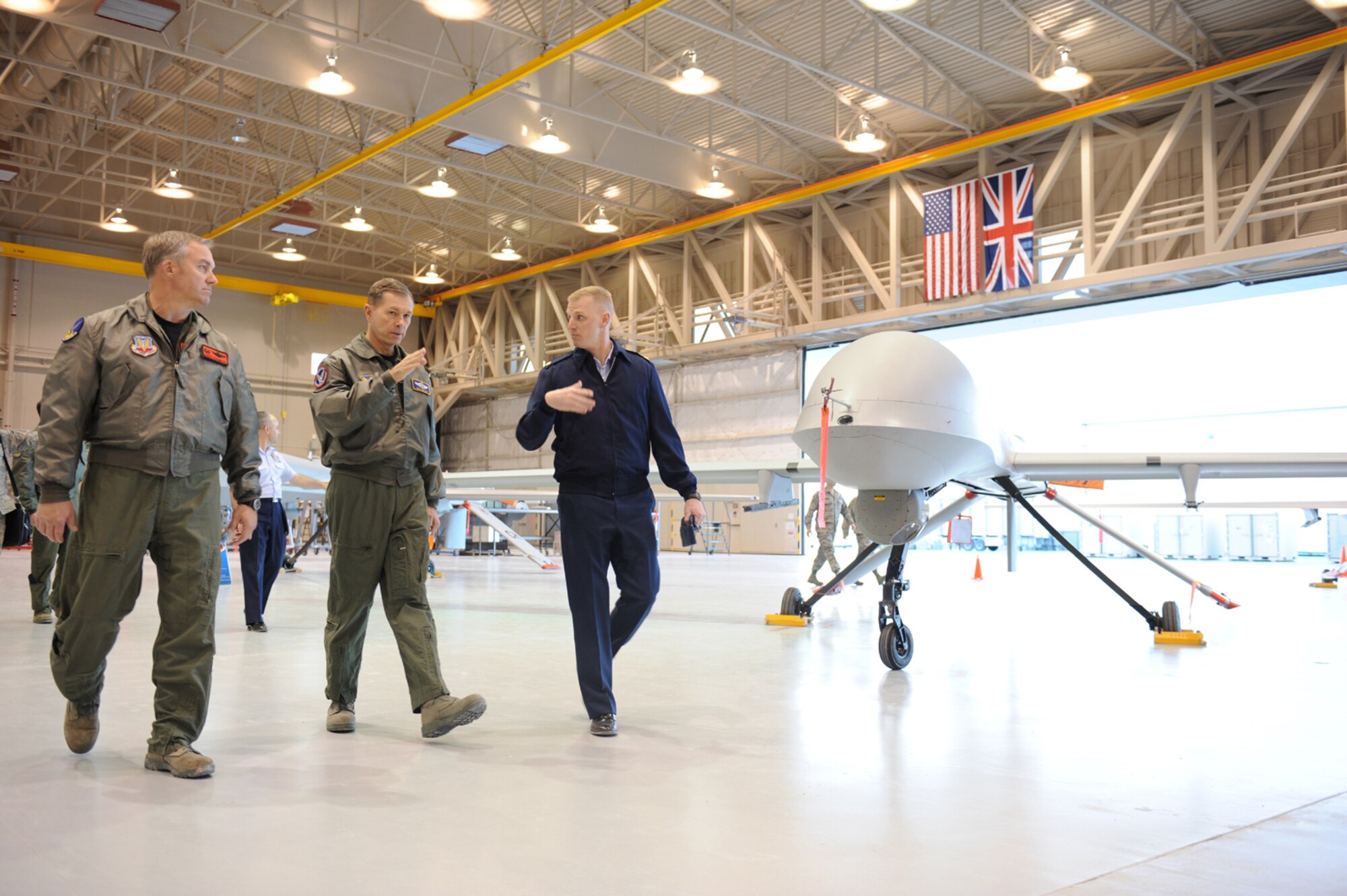 CREECH AFB, Nev. -- Colonel Chris Chambliss, 432d Wing and 432d Air Expeditionary Wing commander, Gen. William M. Fraser III, Vice Chief of Staff of the Air Force, and Maj. Andrew Ruth, 432d Aircraft Maintenance Squadron commander, discuss MQ-1B Predator operations and abilities during General Fraser’s visit to Creech Air Force Base Jan. 12. (U.S. Air Force Photo/Senior Airman Brian Ybarbo) 