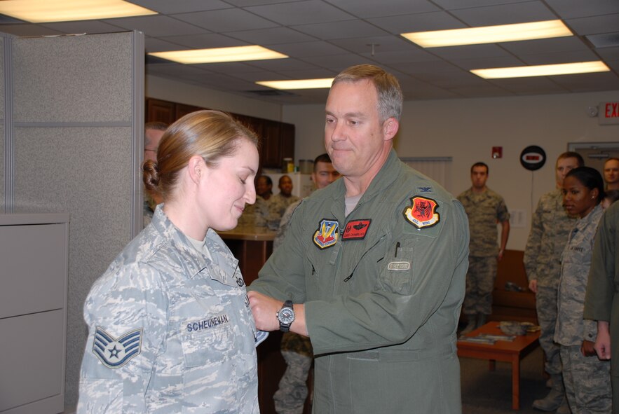 CREECH AFB, Nev. – Colonel Chris Chambliss, 432d Wing and 432d Air Expeditionary Wing commander promotes Staff Sgt. Cori Scheuneman, 432d Operations Support Squadron, to the rank of technical sergeant under the Stripes for Exceptional Performers (STEP) program here Jan. 21. STEP promotions reward outstanding and deserving Airmen who work hard and perform superbly. (U.S. Air Force photo/Staff Sgt. Alice Moore) 