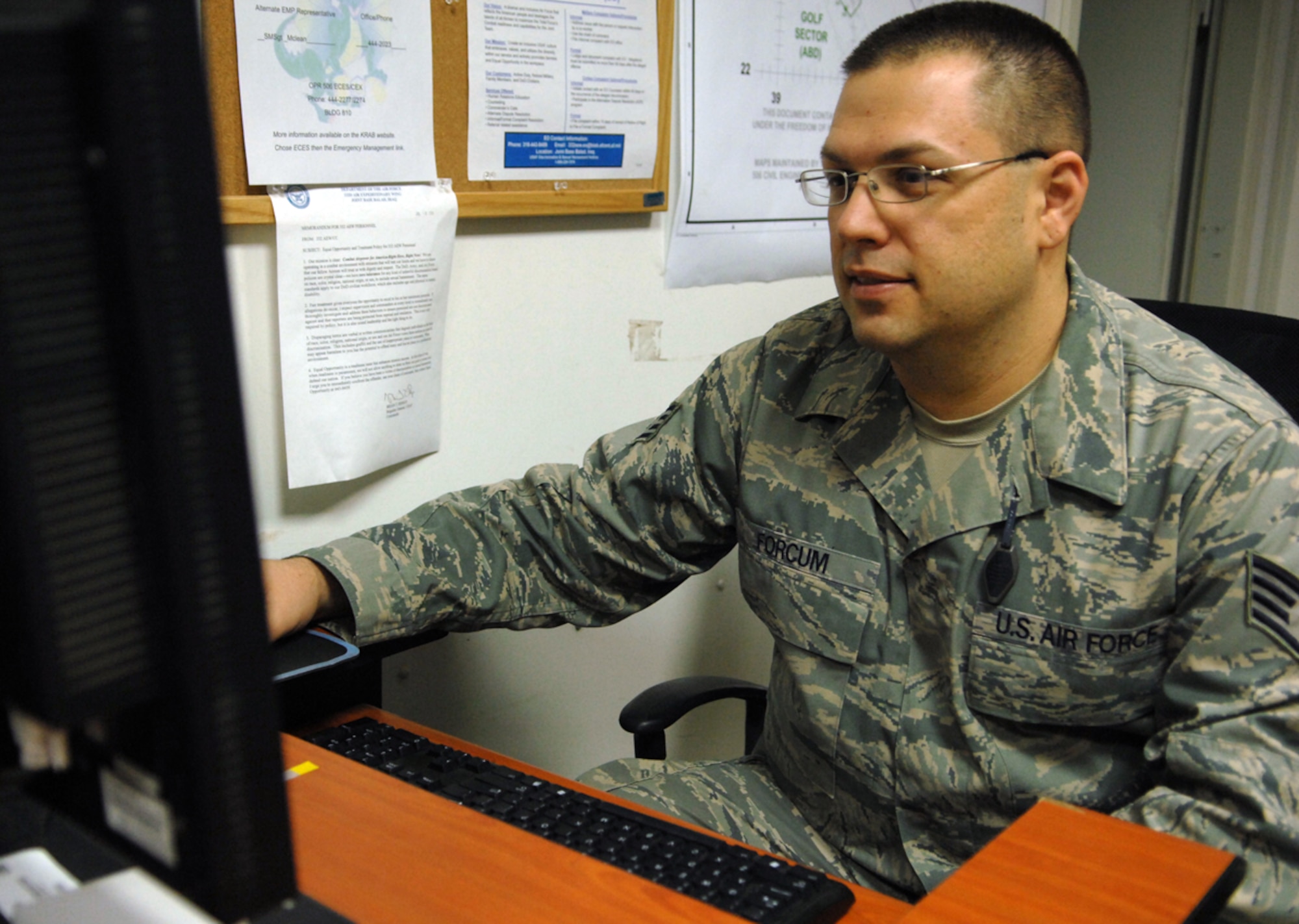 KIRKUK REGIONAL AIR BASE, Iraq -- Team McConnell Staff Sgt. Marcus Forcum, deployed to the 506th Air Expeditionary Group Communications Squadron, assists servicemembers with computer problems and troubleshooting, Jan. 16. He is the assistant non-commissioned officer in charge of system administration and volunteers as a help desk technician. Sergeant Forcum calls Sacramento, Calif. home.  (U.S. Air Force photo by Senior Airman Jessica Lockoski)
