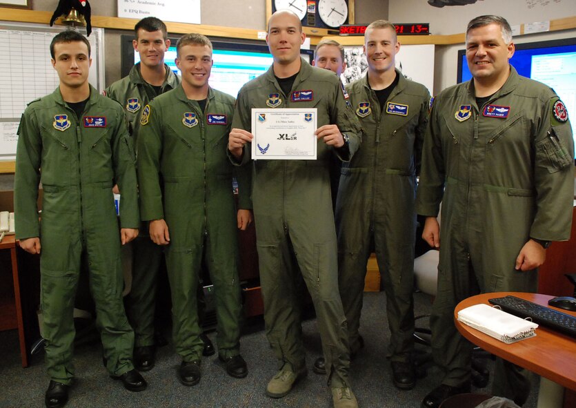 LAUGHLIN AIR FORCE BASE, Texas -- First Lt. Marc Sallee, 87th Flying Training Squadron, displays his XLer of the Week award with fellow members of the 87th FTS here Jan. 27. (U.S. Air Force photo by Airman 1st Class Sara Csurilla)