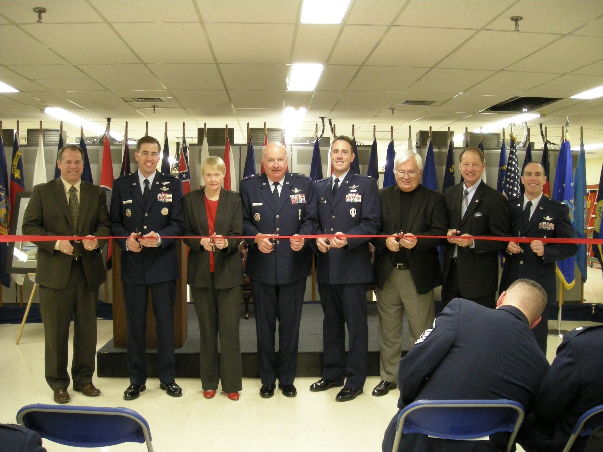 Major General Thomas F. Deppe, Vice Commander, Air Force Space Command, cuts a ribbon with 20 Space Control Squadron commander Lt. Col. Thomas Falzarano and former commanders. The ribbon symbolizes the step ahead for the squadron's next 40 years.  (USAF photo)                  