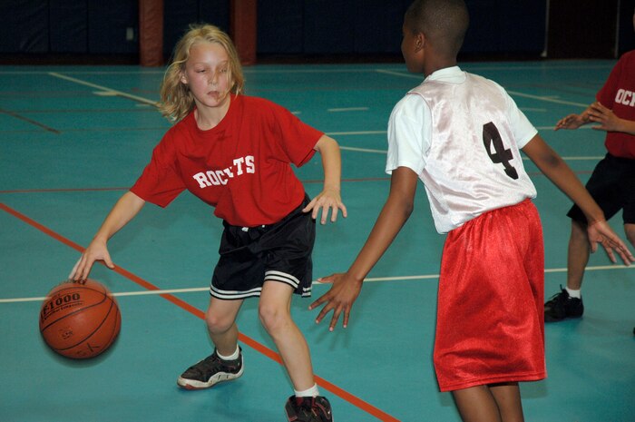 Alex Jackson tries to dribble around defensive player Nick Tolbert during the youth basketball game at the Youth Programs gym Jan. 27. Charleston AFB 1 Eagles defeated the Hannah Rockets 23-15. Alex, Hannah Rockets, is the son of Che Jackson. Nick, Charleston AFB 1 Eagles, is the son of Nicole Tolbert from the Naval Weapons Station, Charleston. (U.S. Air Force photo/Staff Sgt. Marie Cassetty)