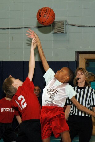 Robert Meuller, left, and Nicholas Tolbert, right, tip-off at the start of the youth basketball game at the Youth Programs gym on Charleston AFB Jan. 27. Charleston AFB 1 Eagles defeated the Hannah Rockets 23-15. Robert, Hannahan Rockets, is the son of Matthew and Bridget Mueller. Nicholas, Charleston AFB 1 Eagles, is the son of Nicole Tolbert from the Naval Weapons Station, Charleston. (U.S. Air Force photo/Staff Sgt. Marie Cassetty)