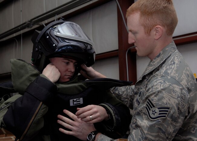 Staff Sgt. George Schmalz assists Staff Sgt. Bryan Worley with a bomb suit for training Jan. 26 on Charleston AFB. Explosive ordnance disposal Airmen routinely train so they can be proficient during disposal of explosive devices. Sergeant Worley is an EOD technician with the 437th Civil Engineer Squadron. (U.S. Air Force photo/Senior Airman Katie Gieratz)
