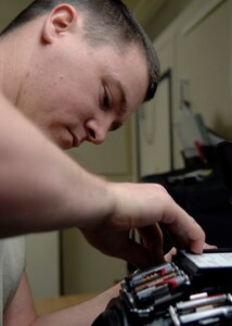 Staff Sgt. Bryan Worley places batteries in the helmet for the bomb suit Jan. 26 on Charleston AFB. Explosive ordnance disposal Airmen routinely train so they can be proficient during disposal of explosive devices. Sergeant Worley is an EOD technician with the 437th Civil Engineer Squadron. (U.S. Air Force photo/Senior Airman Katie Gieratz)

