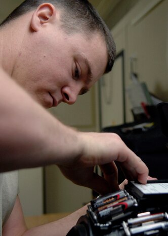 Staff Sgt. Bryan Worley places batteries in the helmet for the bomb suit Jan. 26 on Charleston AFB. Explosive ordnance disposal Airmen routinely train so they can be proficient during disposal of explosive devices. Sergeant Worley is an EOD technician with the 437th Civil Engineer Squadron. (U.S. Air Force photo/Senior Airman Katie Gieratz)