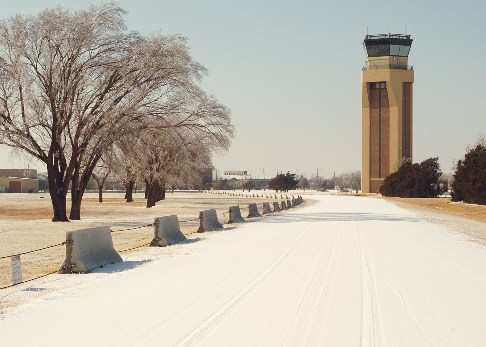ALTUS AIR FORCE BASE, Okla. - The 97th Air Mobility Wing receives the first snow of the year Jan. 26. Due to unsavory weather conditions caused by the winter storm system hitting the central and eastern United States, Altus Air Force Base has had several work delays in order to practice good Operational Risk Management. (U.S. Air Force photo/ Senior Airman Amanda M. Bower) 