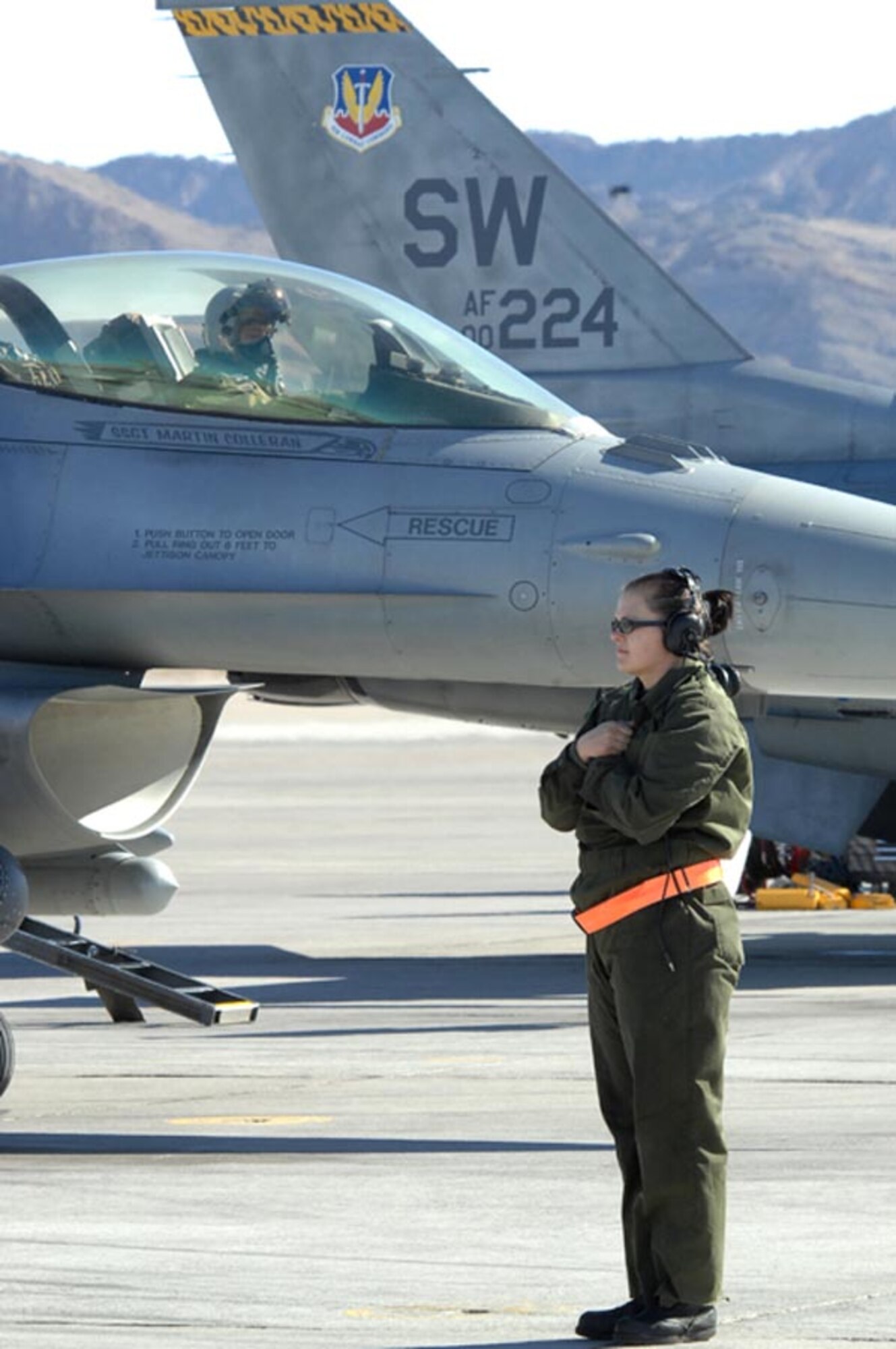 NELLIS AIR FORCE BASE, Nev. -- Senior Airman Andrea Kantnick, 20th Aircraft Maintenance Squadron crew chief, assigned to Shaw AFB, S.C., marshals her F-16CJ for a training mission during Red Flag 09-2 at Nellis AFB Nev., Jan. 27.  Red Flag is a multinational exercise providing a realistic environment to practice combat scenarios. The experience gained during the exercise is vital to the survival of the pilots in combat.  (U.S. Air Force photo/Senior Airman Brian Ybarbo)   