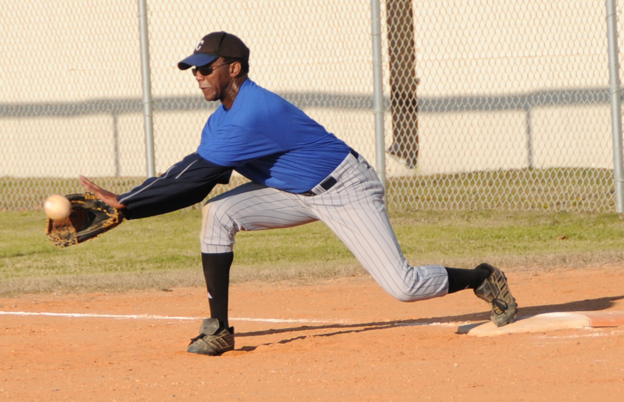 Chief Master Sgt. Lawrence Kirby, commandant of the Mathies NCO Academy, stretches for an out at first base during the Wingman Day Eagles vs. Chiefs softball game, Jan. 22.  The Chiefs won, 19-6.  For more photos and a video of the Wingman Day run that kicked off the day’s activities,  log on to the base’s public Web site, http://www.keesler.af.mil.  (U.S. Air Force photo by Kemberly Groue)