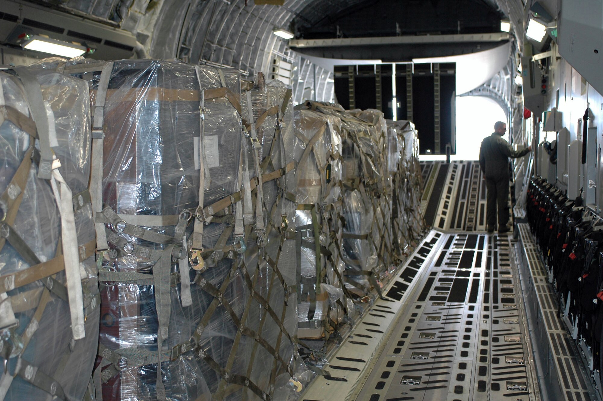 Master Sgt. Mike Wright prepares a C-17 Globemaster III to unload humanitarian cargo Jan. 18 at the Managua International Airport, Nicarauga. Approximately 18,000 pounds of cargo consisting of desks, chairs, file cabinets and books were delivered for use at a Nicaraugan university library. Sergeant Wright is a loadmaster with the Air Force Reserve's 326th Airlift Squadron from Dover Air Force Base, Del. (U.S. Air Force photo/Capt. Marnee A.C. Losurdo)
