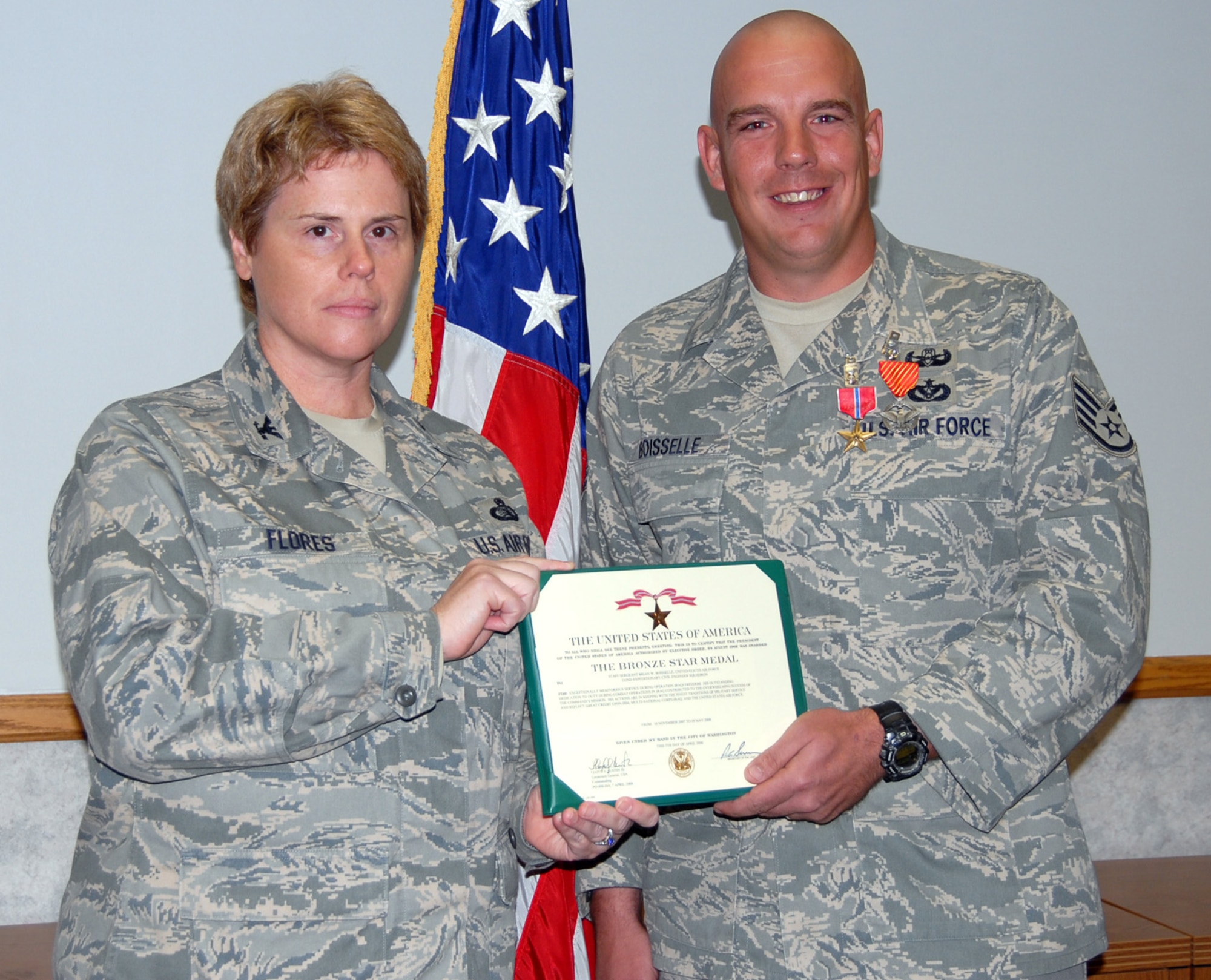 Col. Nancy Flores, 95th Air Base Wing vice commander presents Staff Sgt. Brian Boisselle with the Bronze Star Medal Jan. 27.  Sergeant Boisselle recieved the award for his work as an EOD team leader at Logistics Support Area Anaconda and Forward Operating Base Paliwoda from November 2007 to May 2008. (Air Force photo by Airman 1st Class William O'Brien)