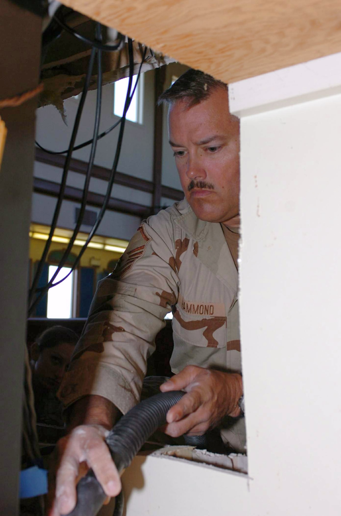 Master Sgt. Stephen Hammond vacuums drywall and sawdust out of the sound booth in the Naval Station Guantanamo Bay's base chapel Jan. 17 at Guantanamo Bay, Cuba. Sergeant Hammond and his team completed more than 150 projects for both Joint Task Force Guantanamo and the Naval Station. JTF Guantanamo provides support to the Office of Military Commissions, to law enforcement and to war crimes investigations. Sergeant Hammond is the shop manager for Joint Task Force Guantanamo's 474th Expeditionary Civil Engineering Squadron structures team. (U.S. Army photo/Staff Sgt. Emily J. Russell) 
