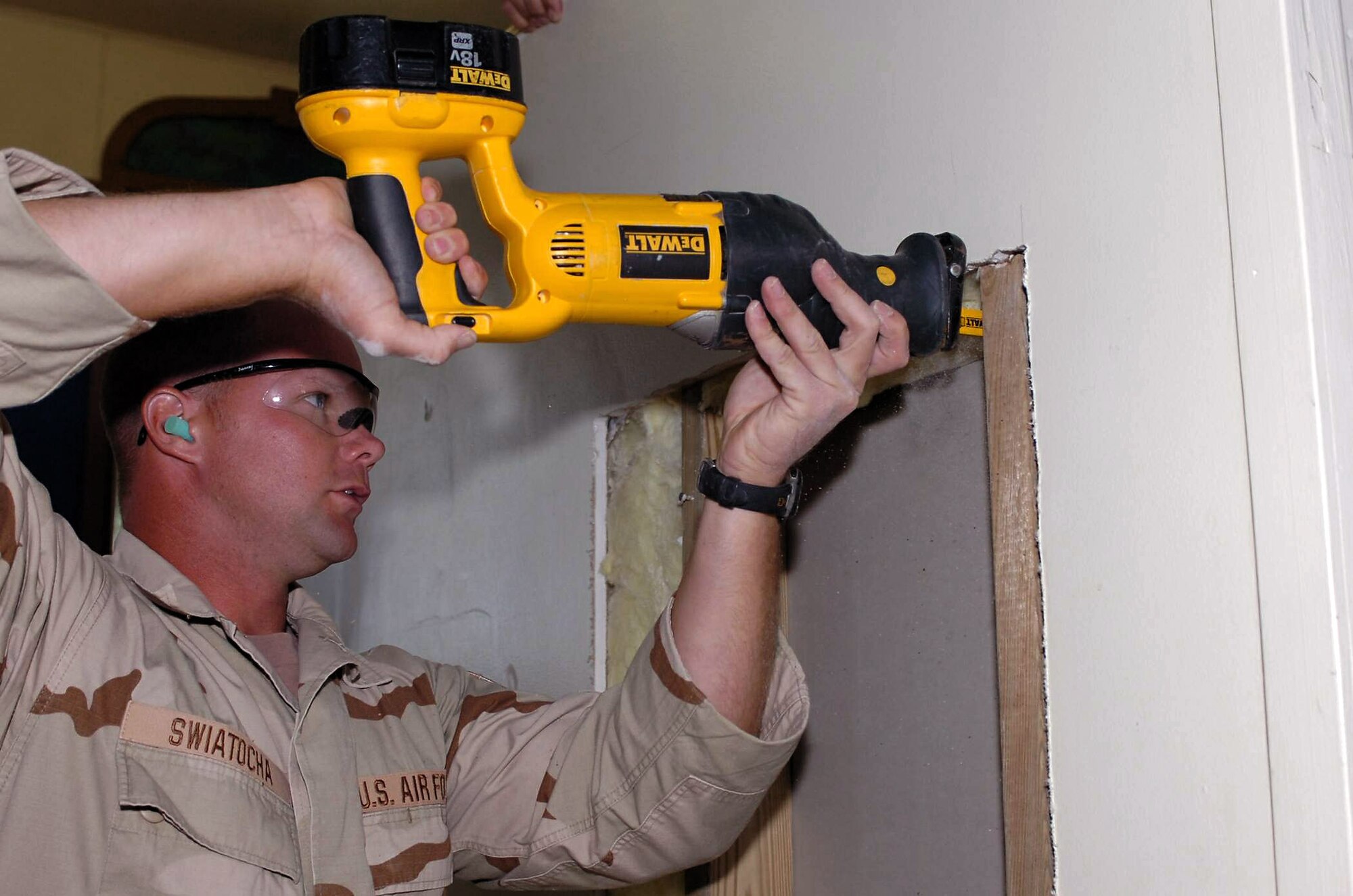 Technical Sgt. Shawn Swiatocha cuts an access door into the rear panel of a sound booth at Naval Station Guantanamo Bay's base chapel Jan. 17 at Guantanamo Bay, Cuba. Sergeant Swiatocha and members of the Joint Task Force Guantanamo's 474th Expeditionary Civil Engineering Squadron structures team completed several construction projects around Naval Station Guantanamo Bay. JTF Guantanamo members conduct intelligence collection, analysis and dissemination for the protection of detainees and personnel working in JTF Guantanamo facilities. Sergeant Swiatocha is a structural craftsman and Air National Guard member. (U.S. Army photo/Staff Sgt. Emily J. Russell) 
