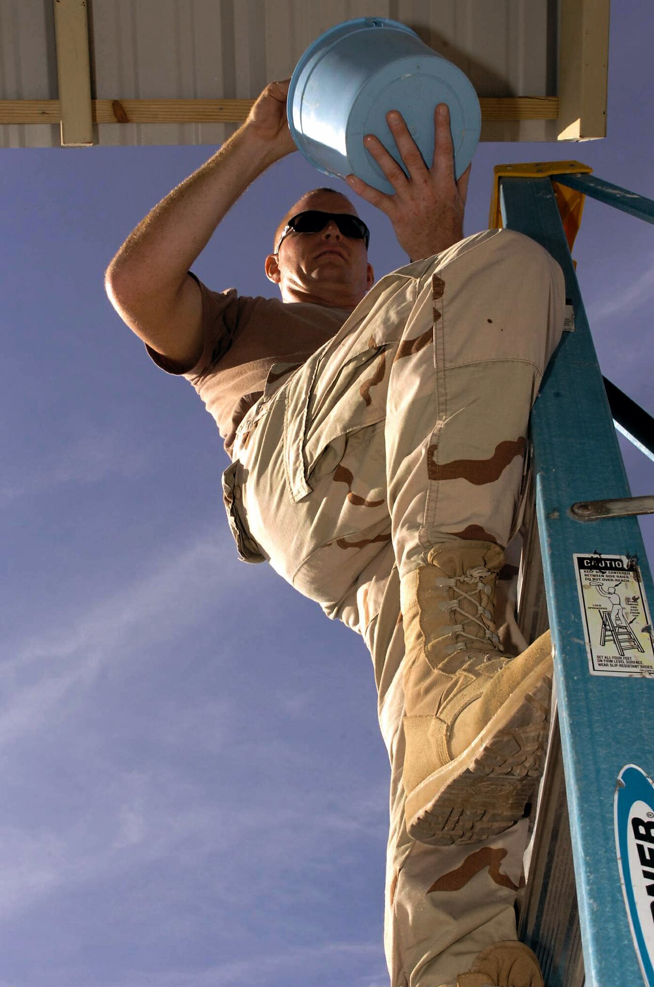 Technical Sgt. Chris Pratt puts the finishing touches on a sun shade outside the Expeditionary Legal Complex Jan. 16 at Guantanamo Bay, Cuba. Sergeant Pratt and members of the Joint Task Force Guantanamo's 474th Expeditionary Civil Engineering Squadron structures team completed several construction projects around Naval Station Guantanamo Bay. JTF Guantanamo conducts safe, humane, legal and transparent care and custody of detained enemy combatants, including those convicted by military commission and those ordered released. (U.S. Army photo/Staff Sgt. Emily J. Russell) 

