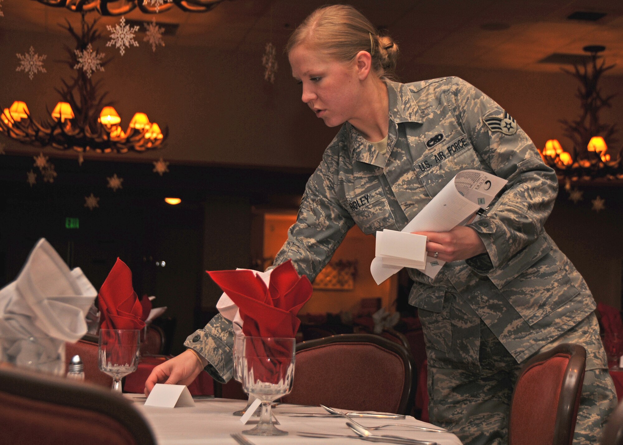 Senior Airman Anna Roley, 354th Fighter Wing Protocol Specialist, reads a seating chart for the 354th FW Fourth Quarter Quartely Awards Luncheon at the Yukon Club Jan. 23. The protocol office is responsible for planning and coordinating all official functions and ceremonies for the wing commander. (U.S. Air Force photo/Airman 1st Class Rachelle Coleman)