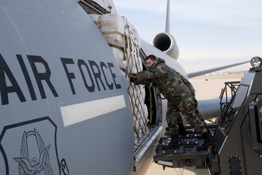 Airman 1st Class Christopher Graybill, 27th Aerial Port Squadron, loads humanitarian cargo aboard a KC-10 aircraft as part of the Denton program.  Story on this page. (Air Force Photo/Master Sgt. Paul Zadach)