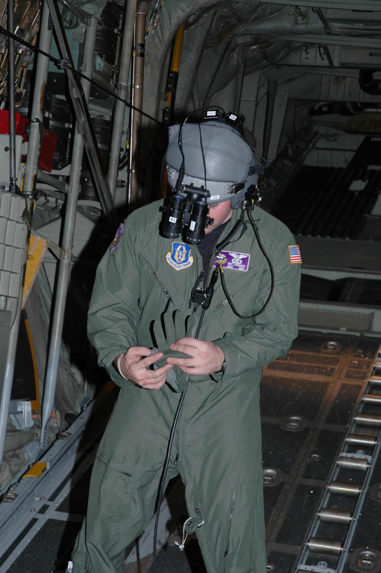 Staff Sgt. Matt Donovan, 96th Airlift Squadron, prepares for a night mission aboard a 934th Airlift Wing C-130. (Air Force Photo/Master Sgt. Darrell Habisch)